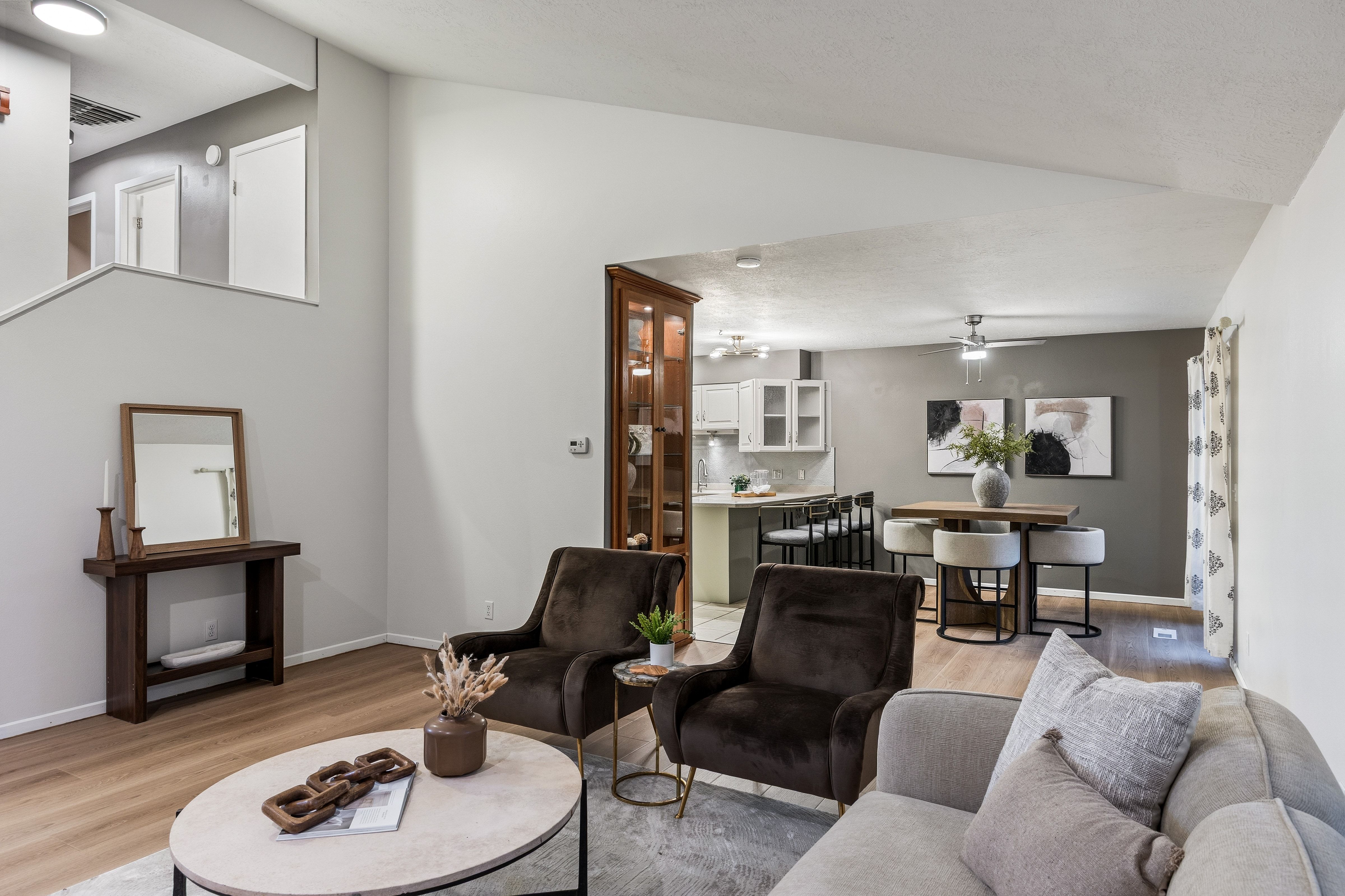 Vaulted ceiling living area with wood-finish flooring