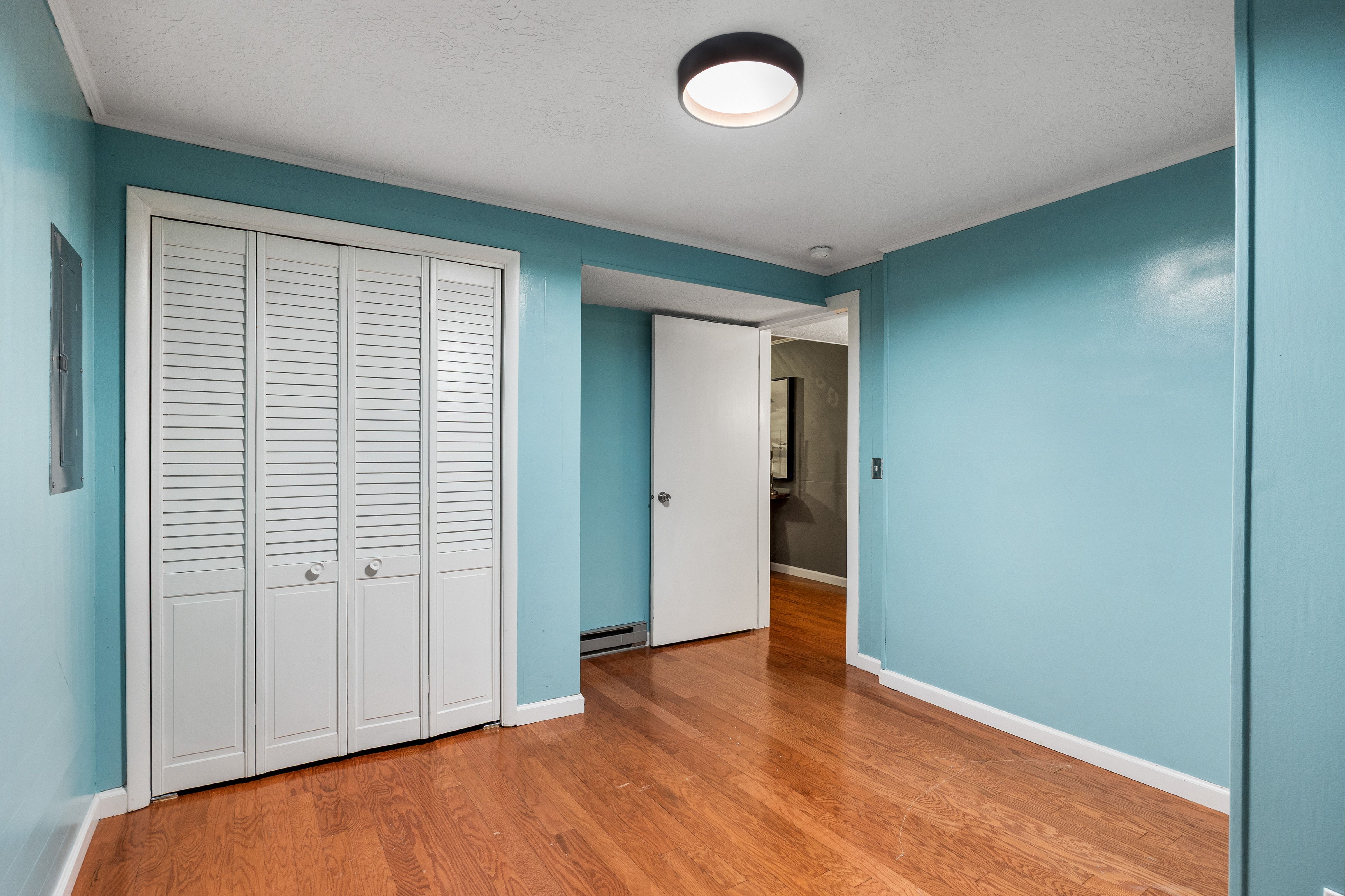 Hardwood-finish flooring complementing light blue walls