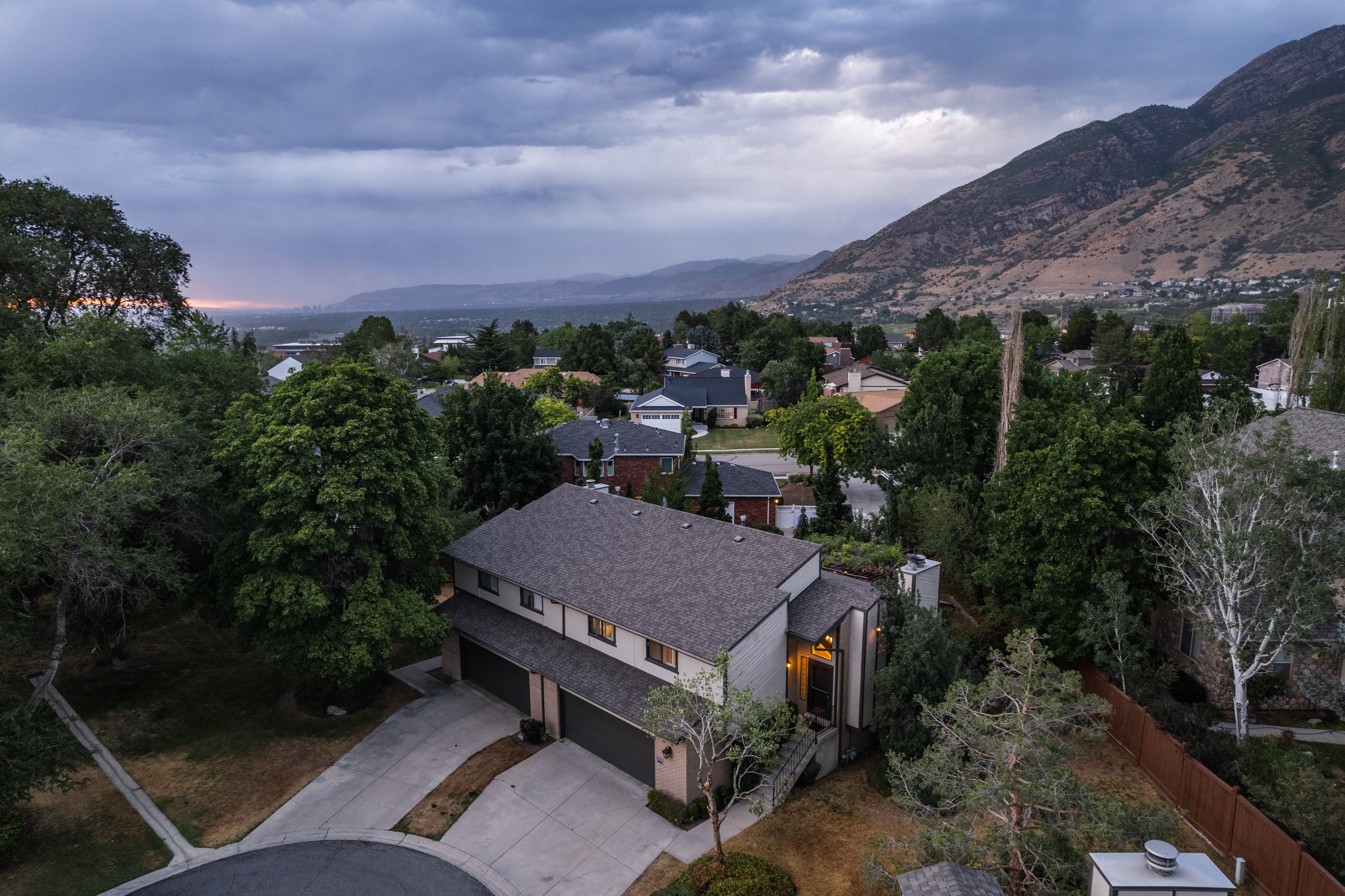 Contemporary property featuring a gray shingle roof and a multi-car garage with individual doors