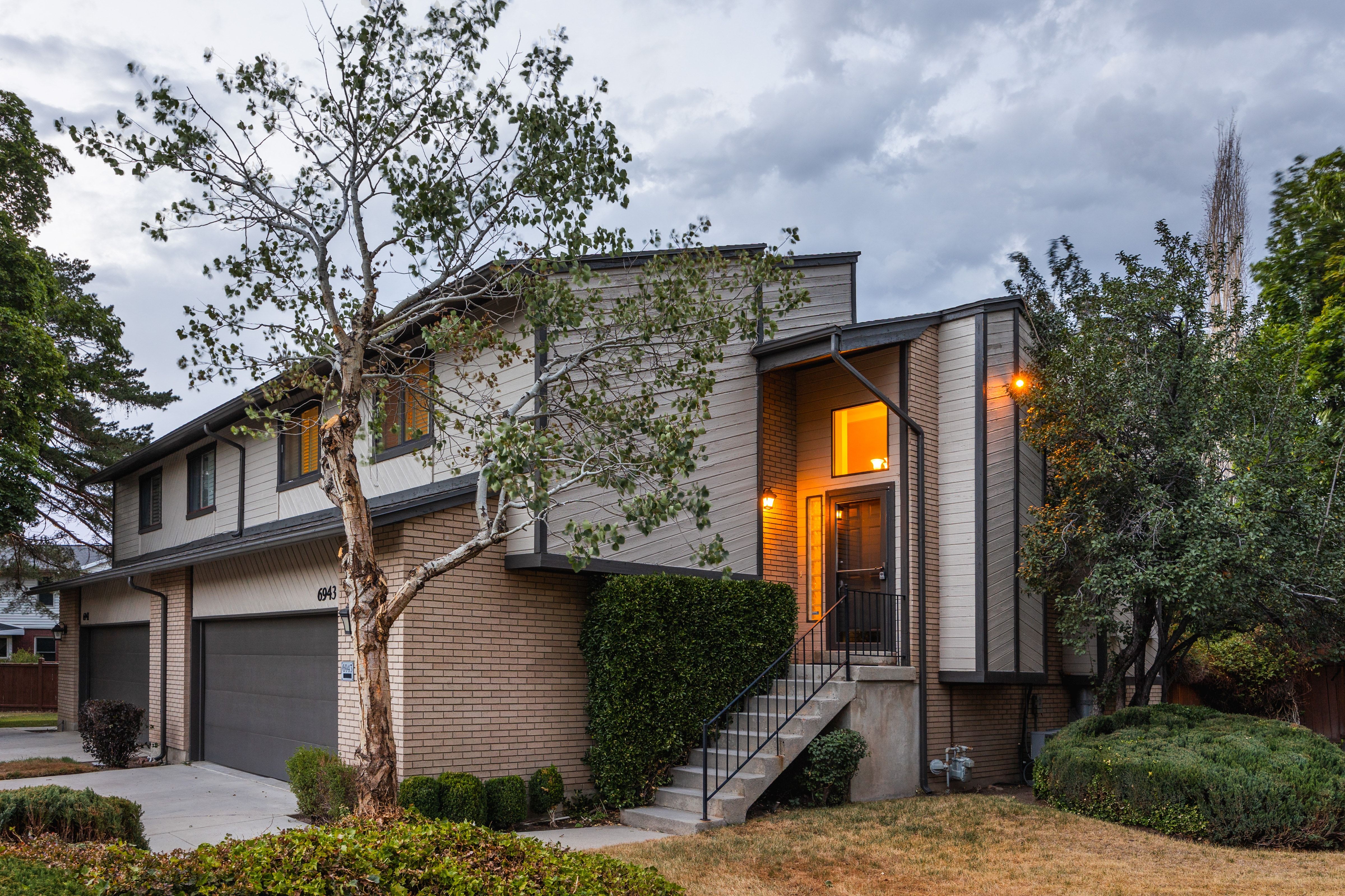 Multi-level property exterior featuring brick and vertical siding accents
