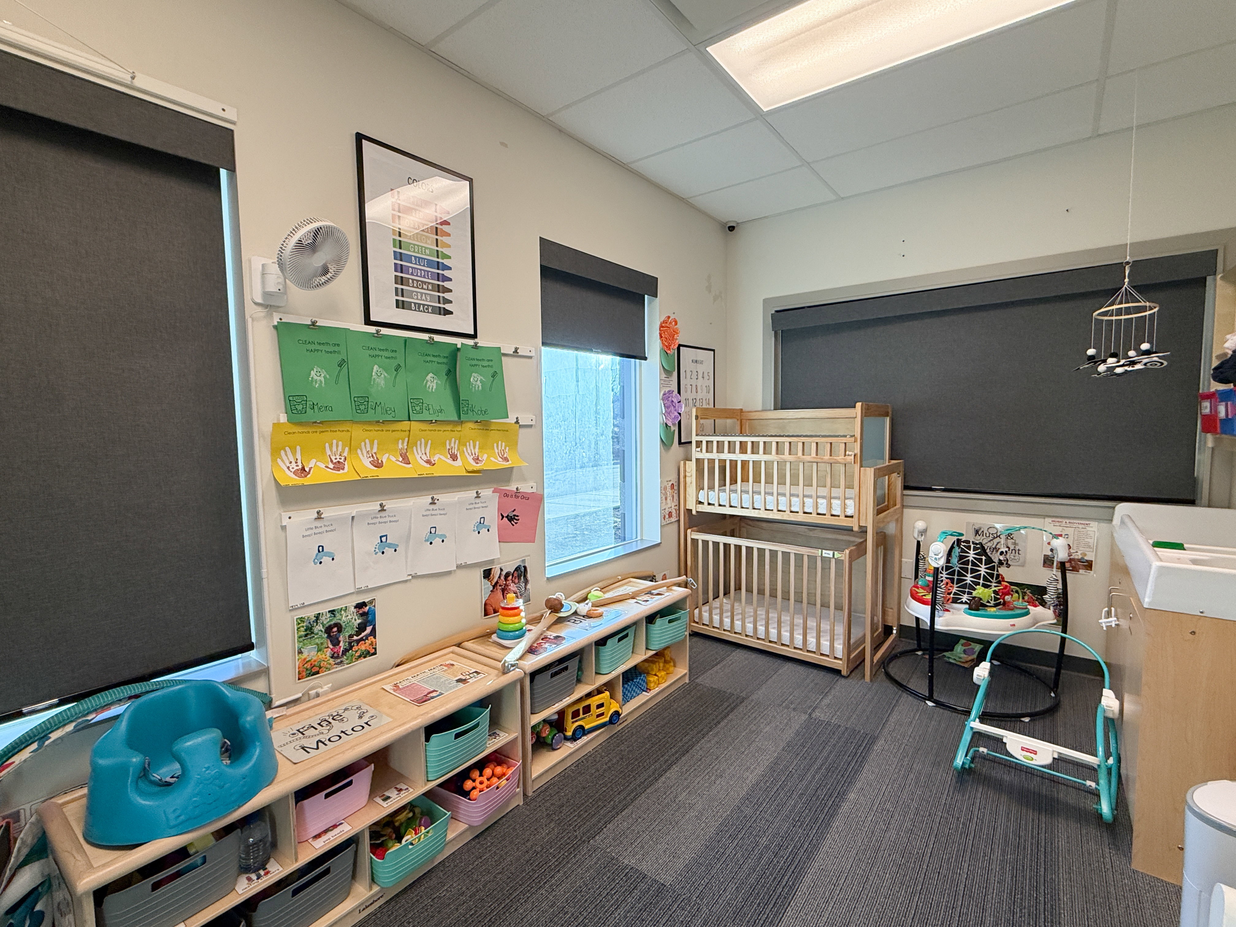 Room featuring wood-finish shelving, wall-mounted display boards, and recessed ceiling lighting
