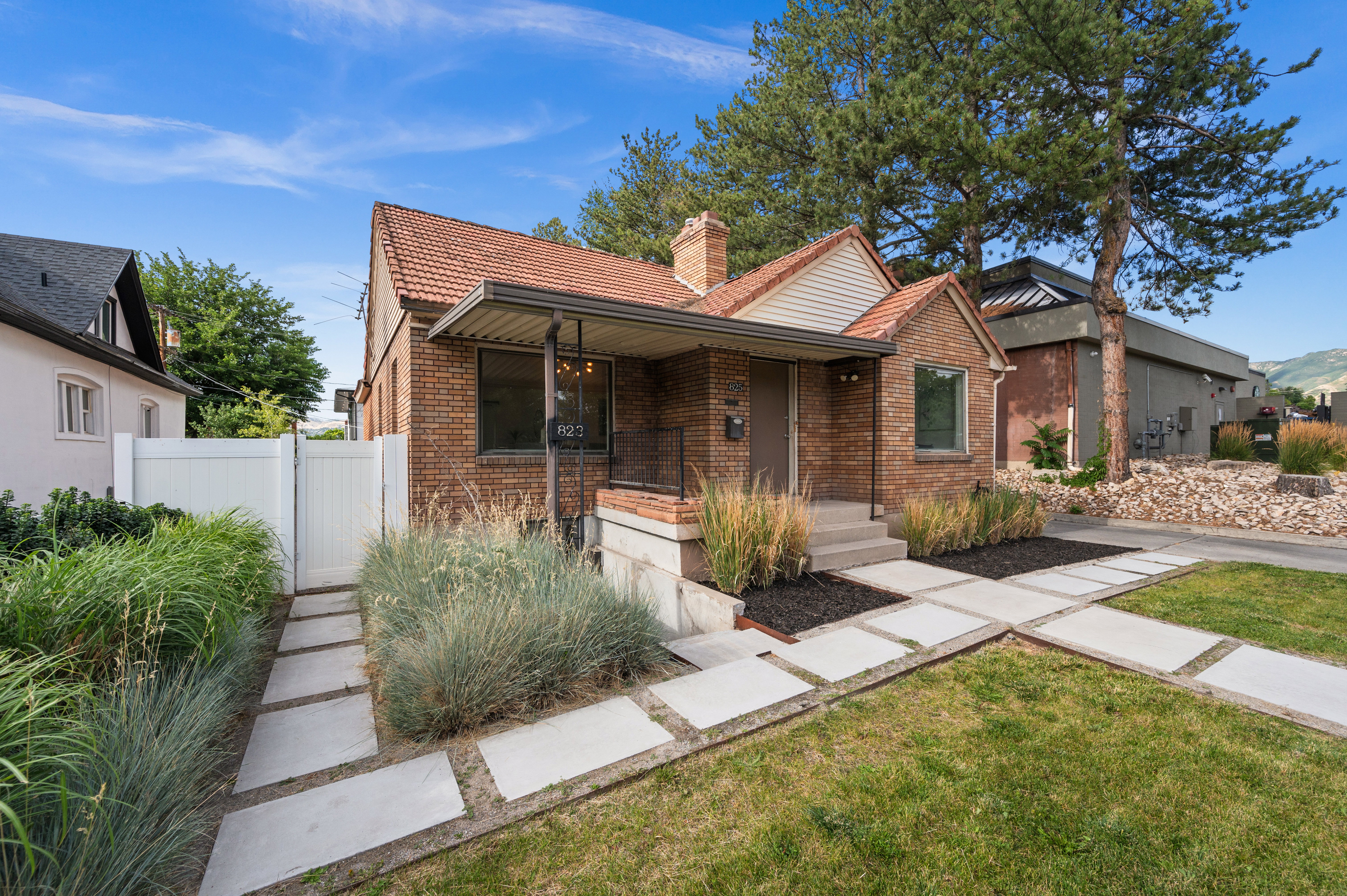 Brick facade residence featuring a covered front entry