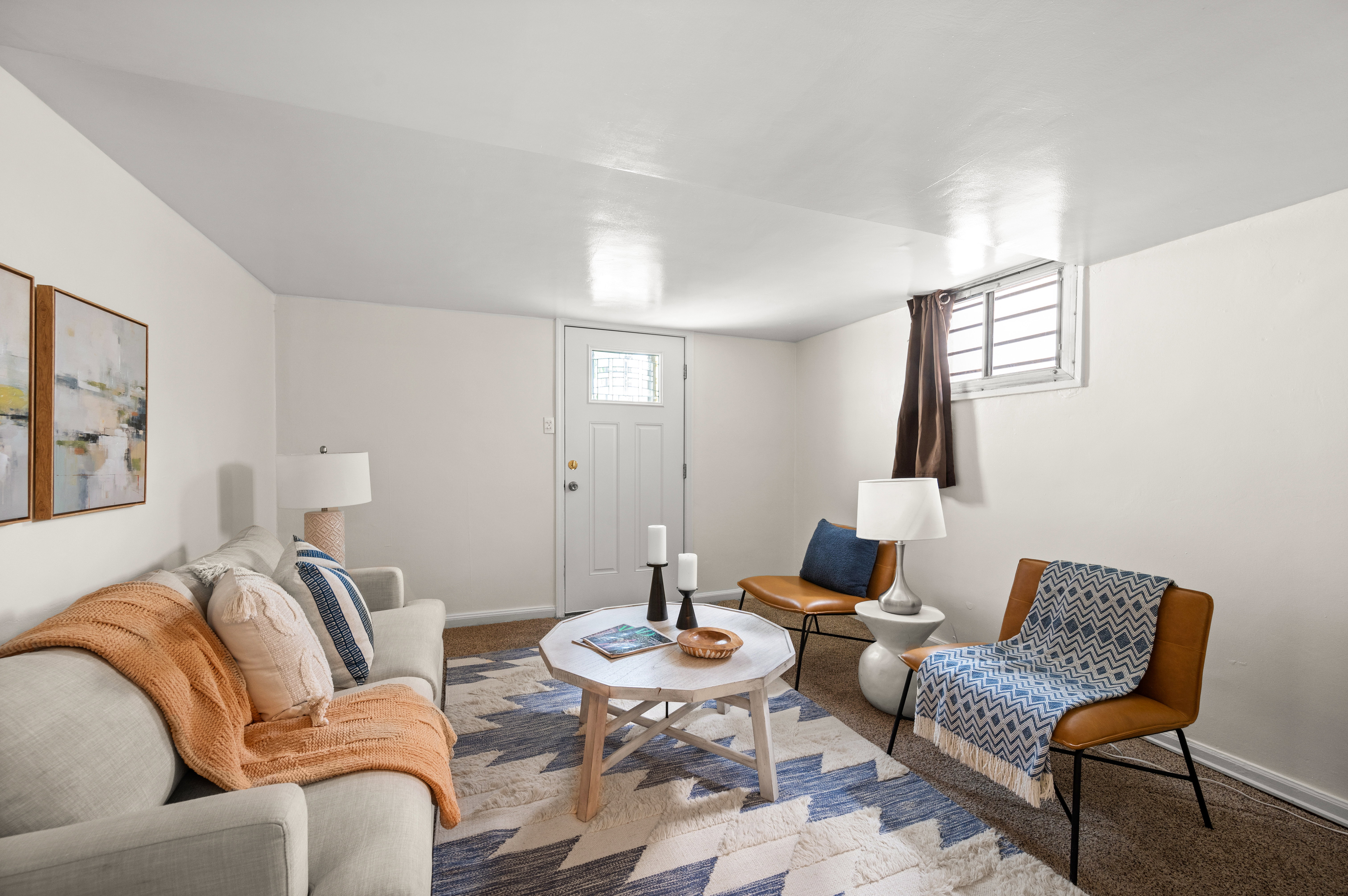 Finished living space featuring soft neutral walls and carpeted flooring
