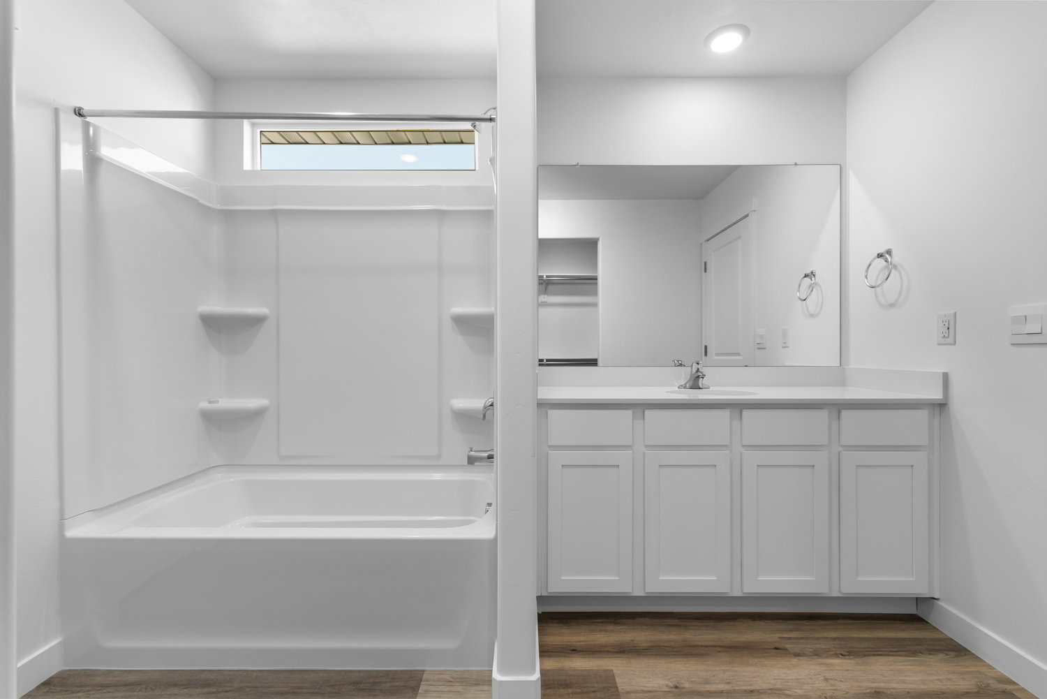 Full bathroom featuring a white tub and shower combination with a transom window