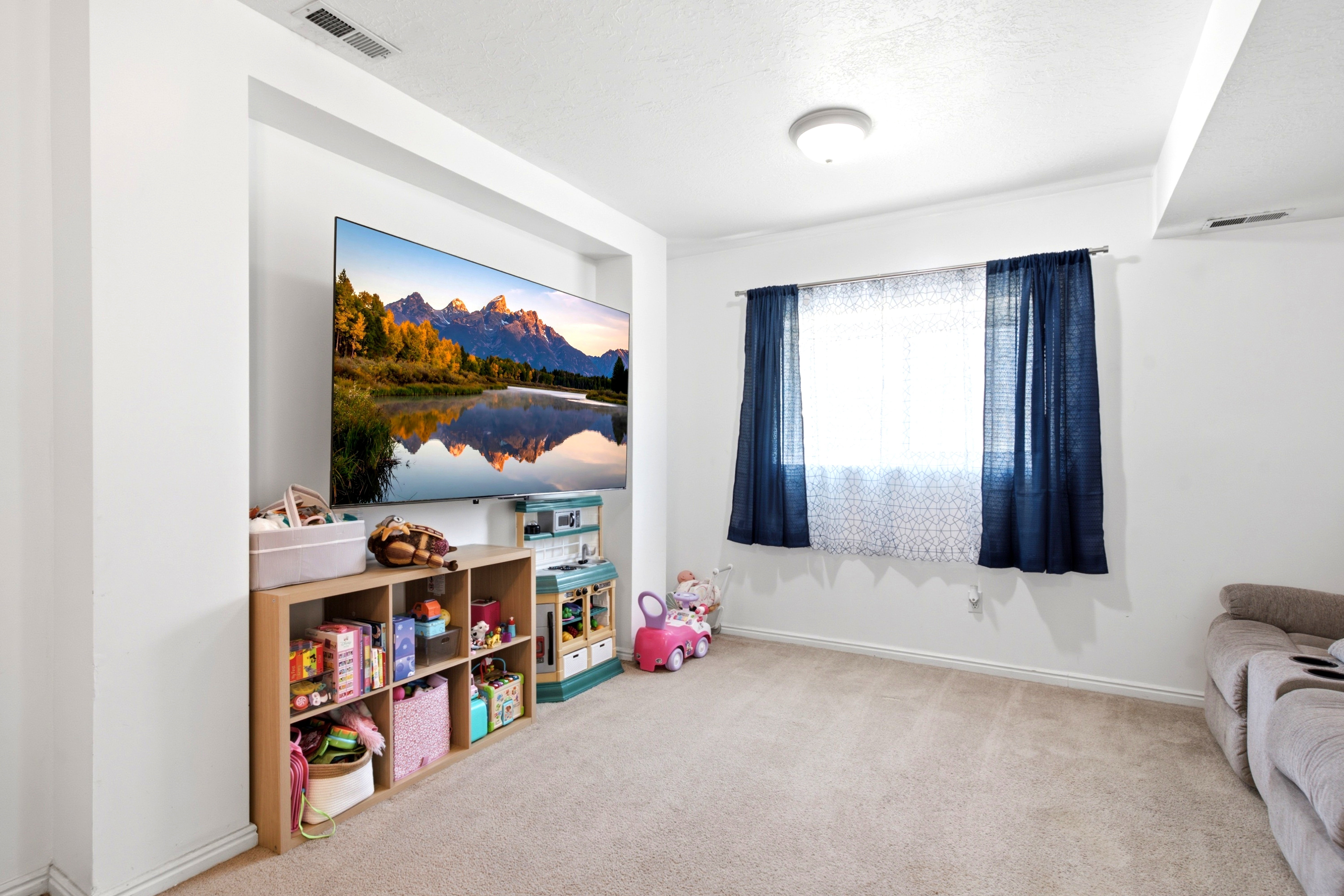 Recessed media niche featuring a wall-mounted display