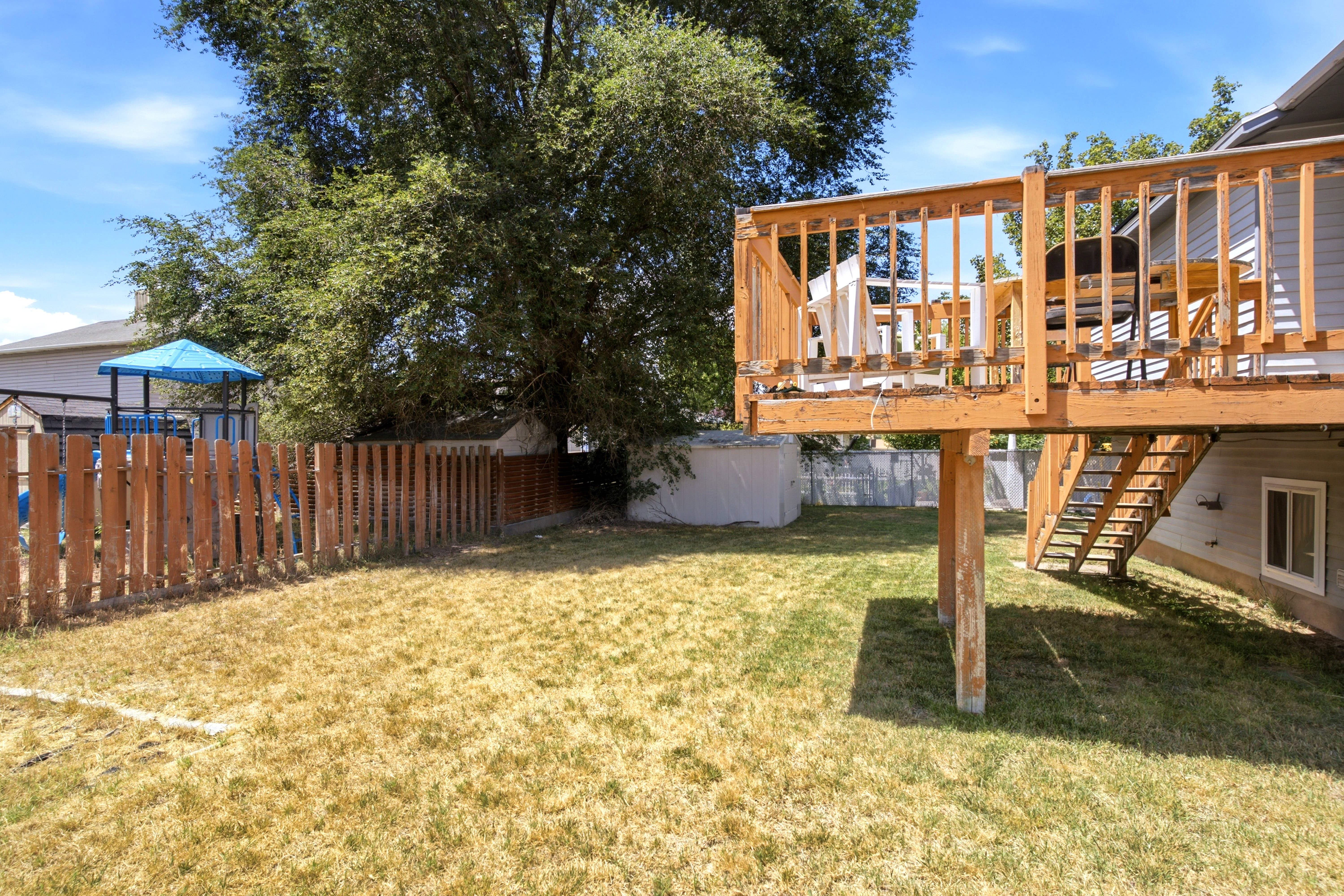 Elevated wood deck with baluster railing and staircase