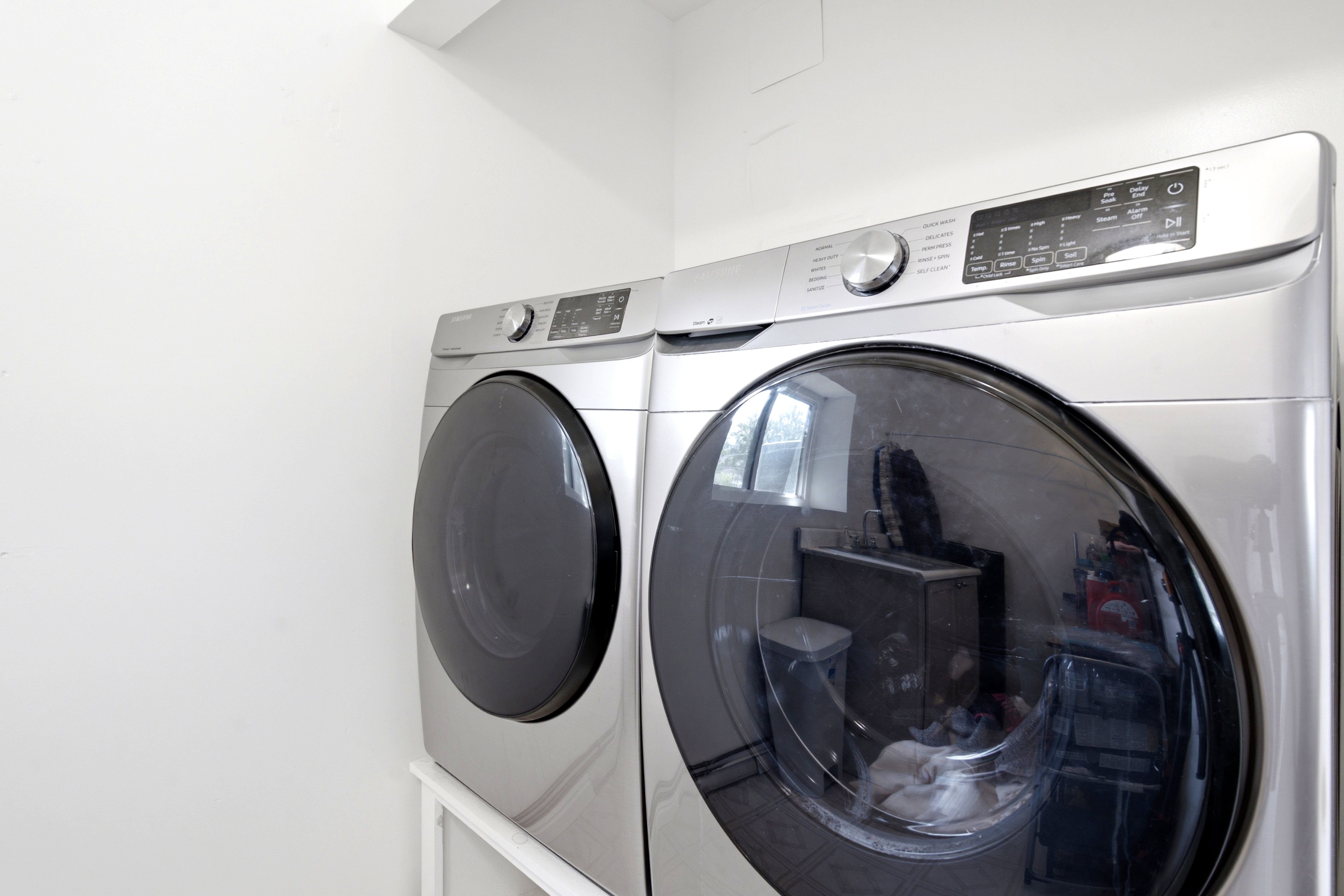 Laundry area featuring two front-loading appliances