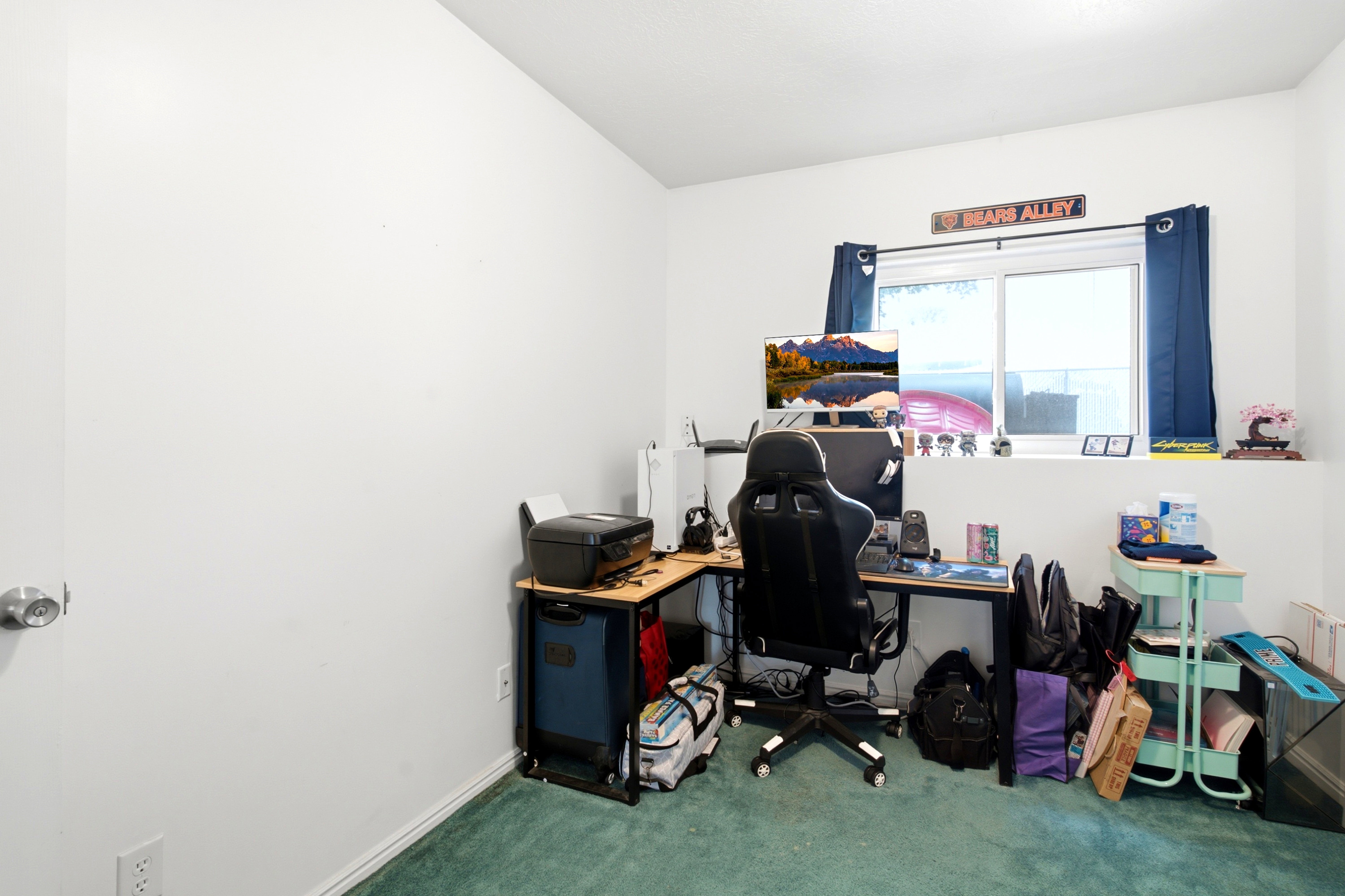 Bedroom featuring light-colored walls and green carpeting