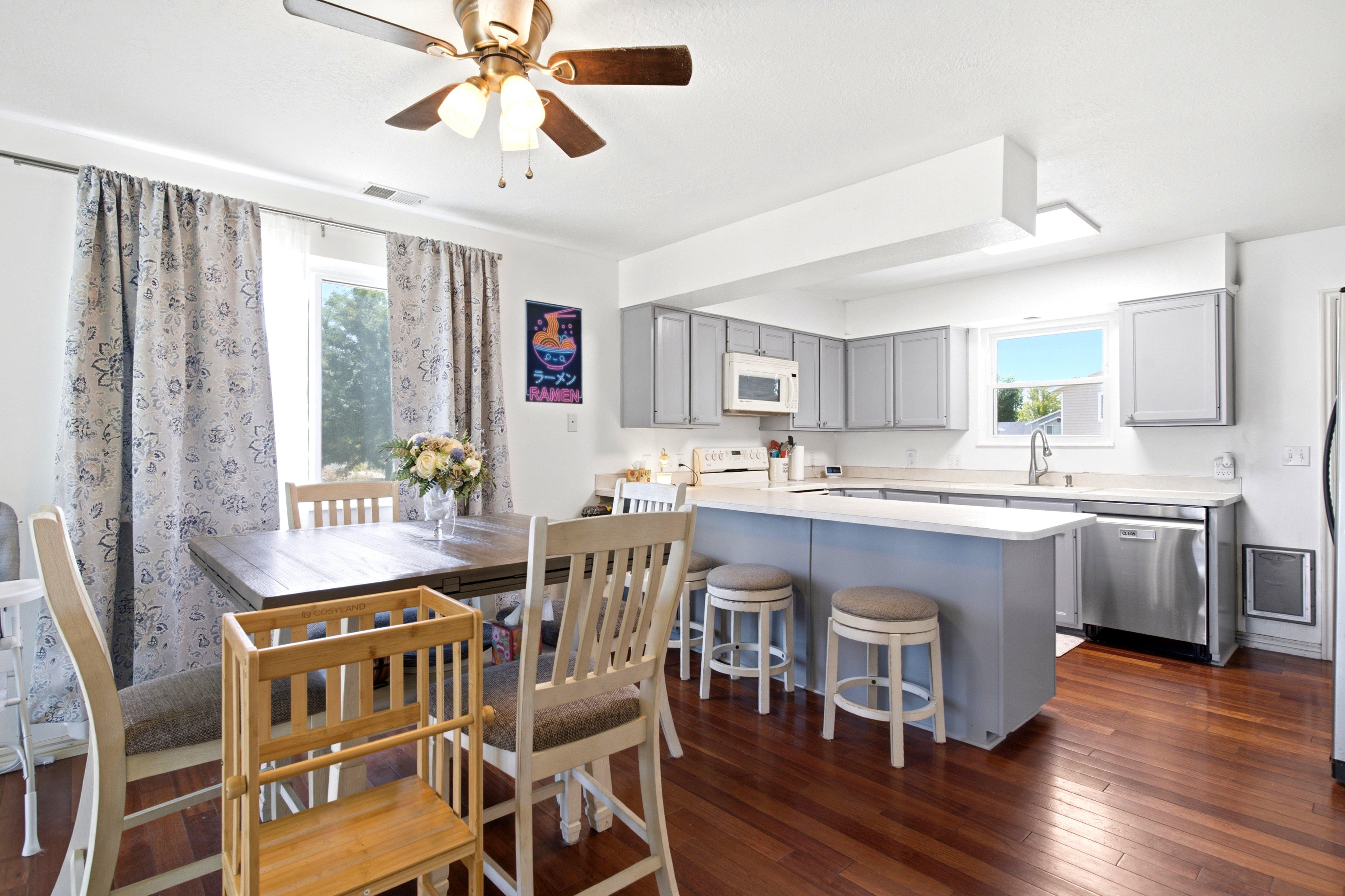 Open concept kitchen and dining area featuring wood-finish flooring