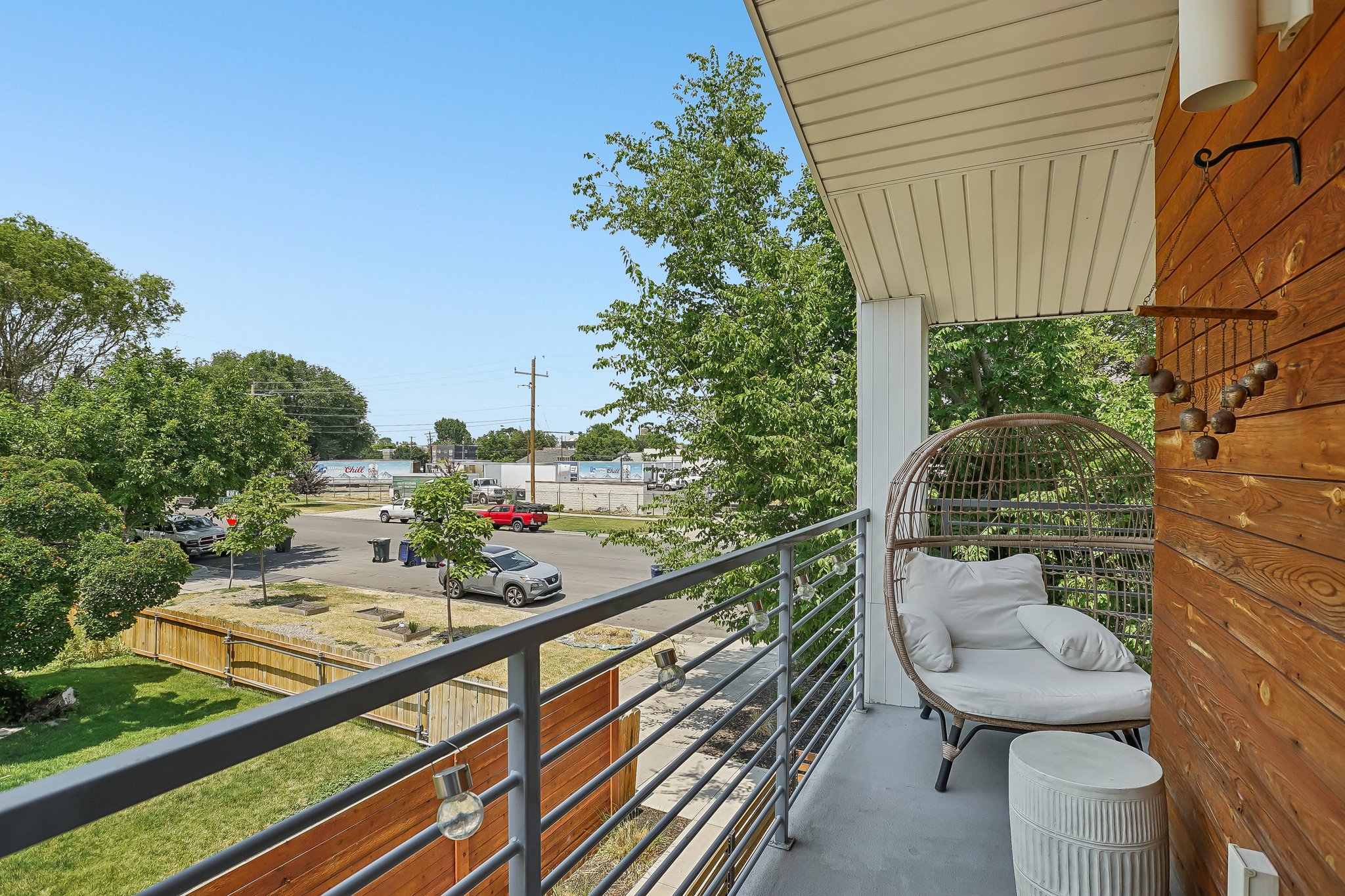 Balcony featuring a horizontal wood plank accent wall, a white support pillar, and a white soffit ceiling