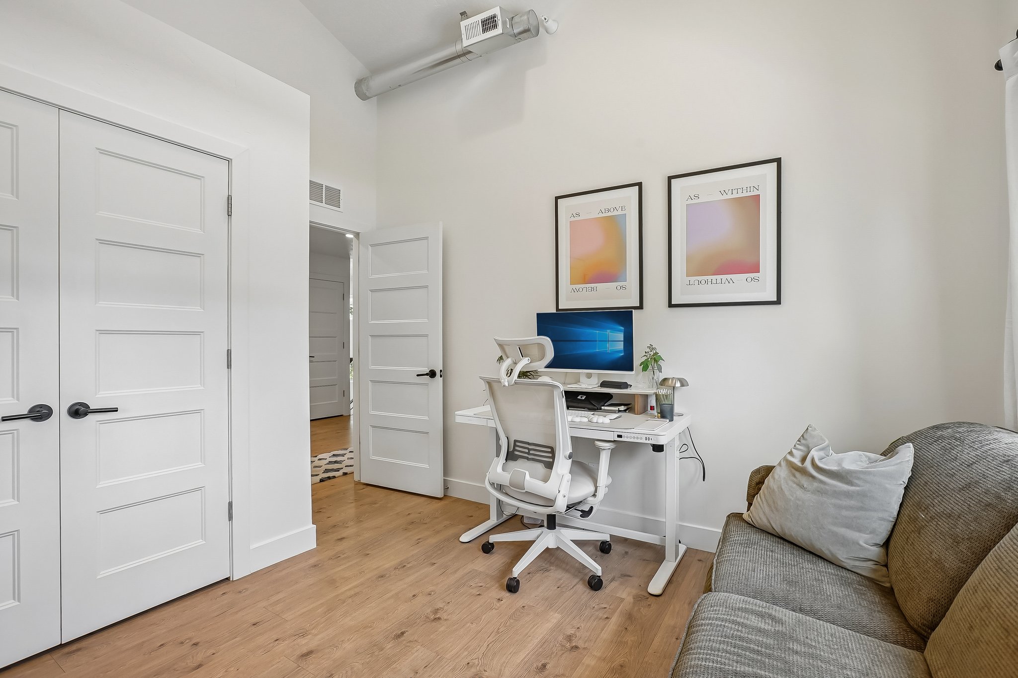 Light wood-finish flooring complements the neutral wall color