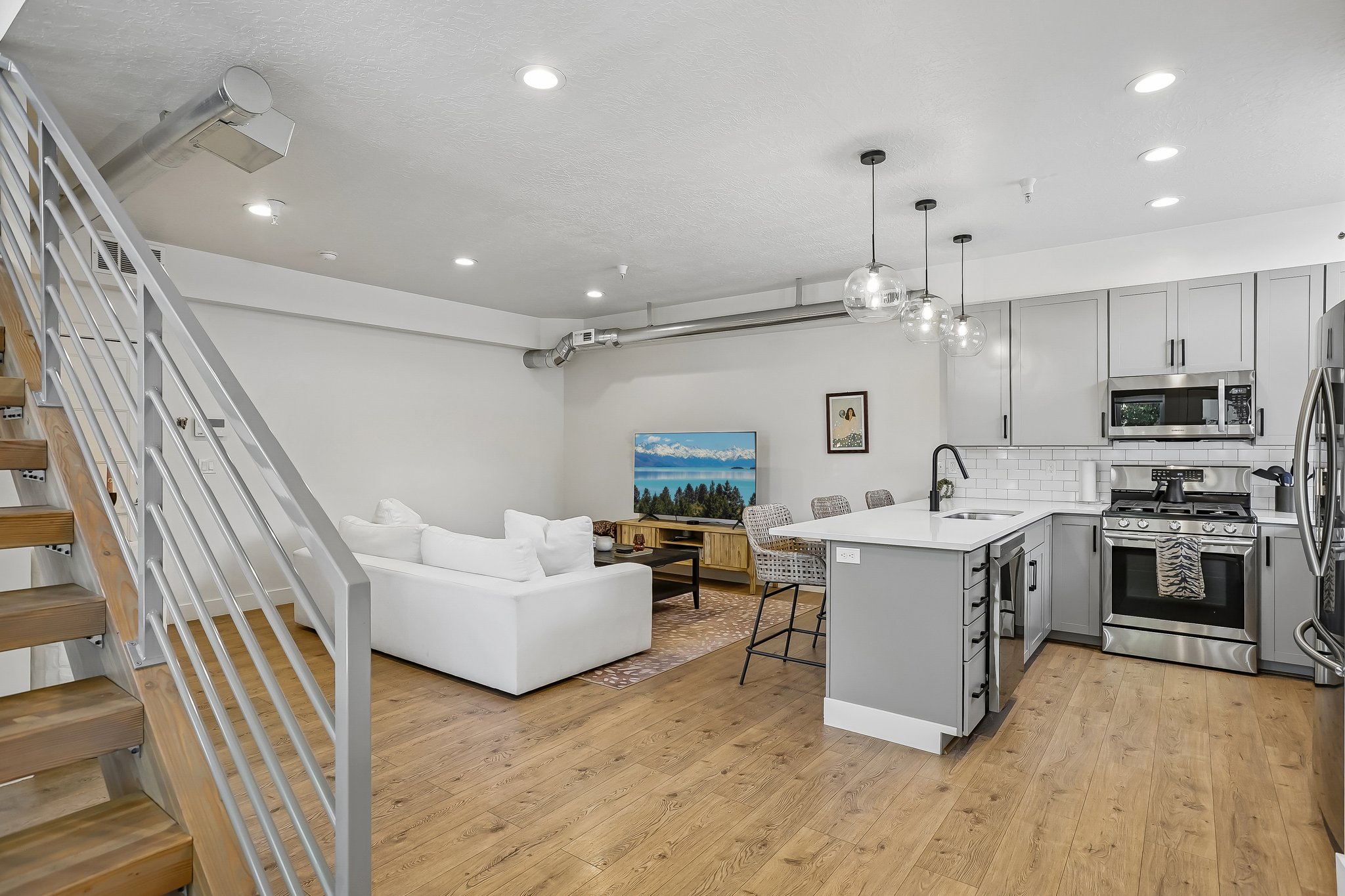 Open concept living area featuring wood-finish flooring