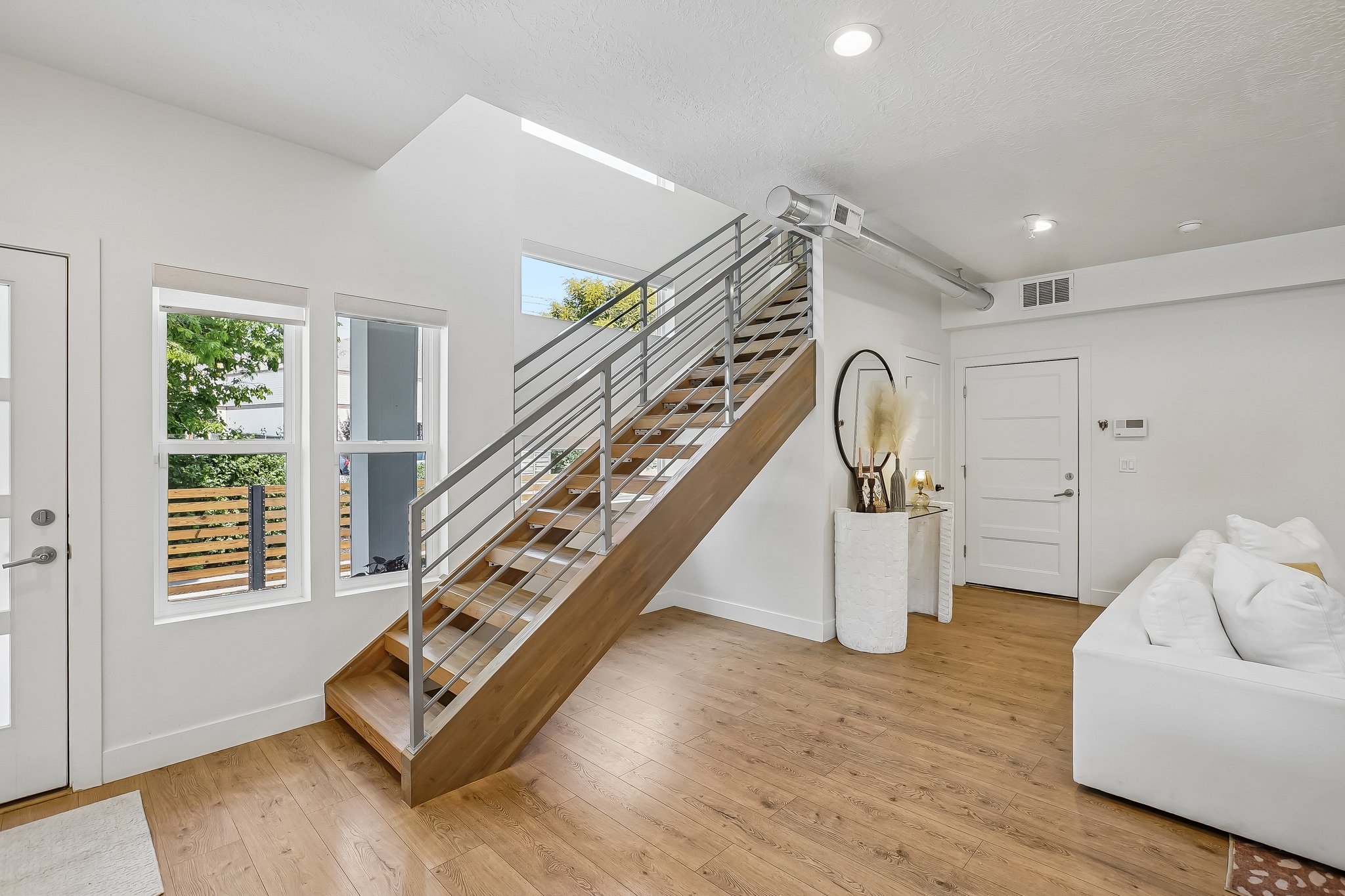 Modern staircase with wood-finish treads and metal railings
