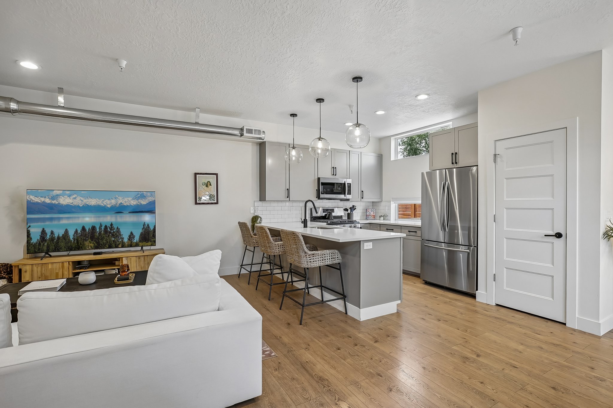 Open concept living space featuring wood-finish flooring