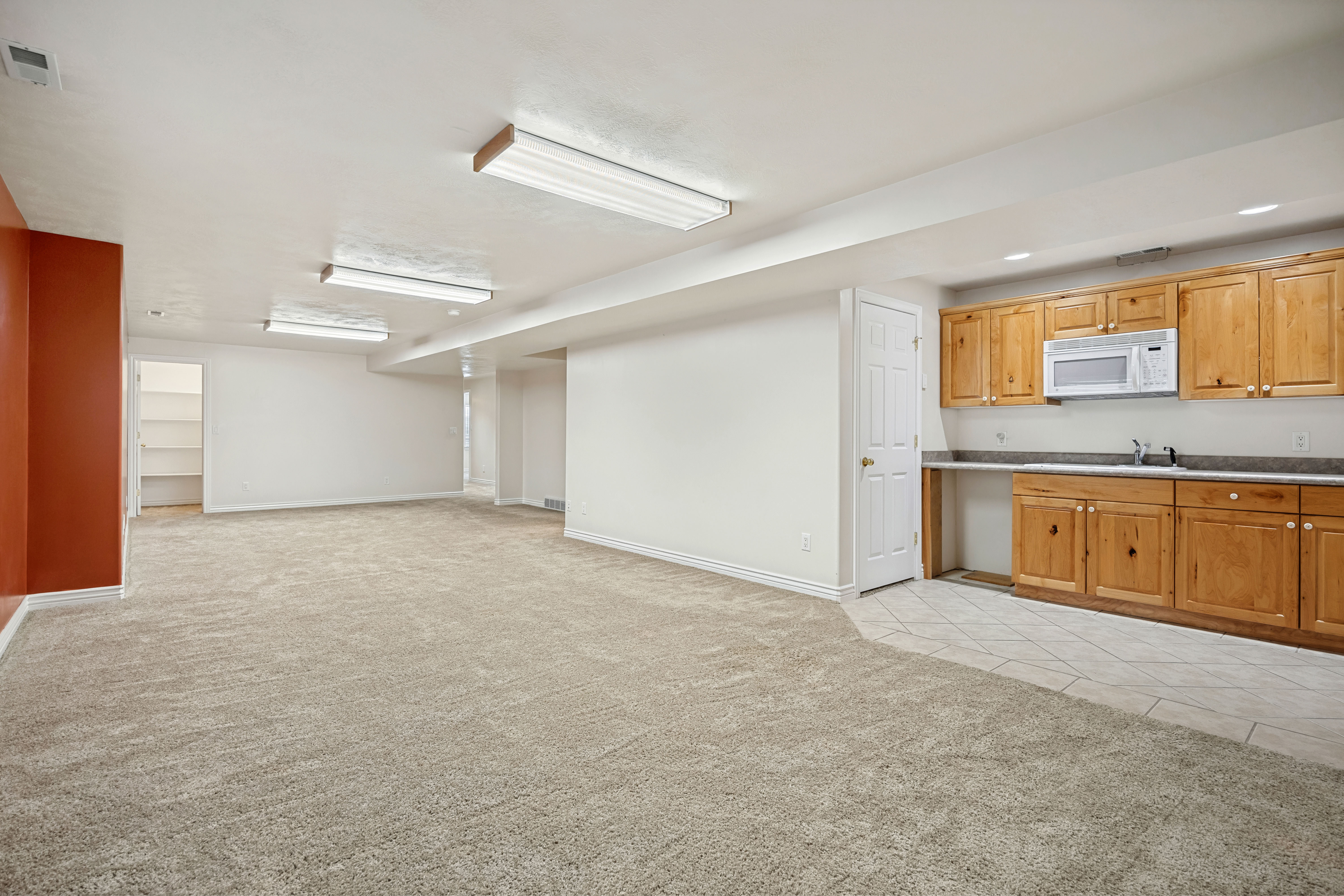 Demonstrates the flow of kitchenette into family room. Easily convert for rental space if desired.