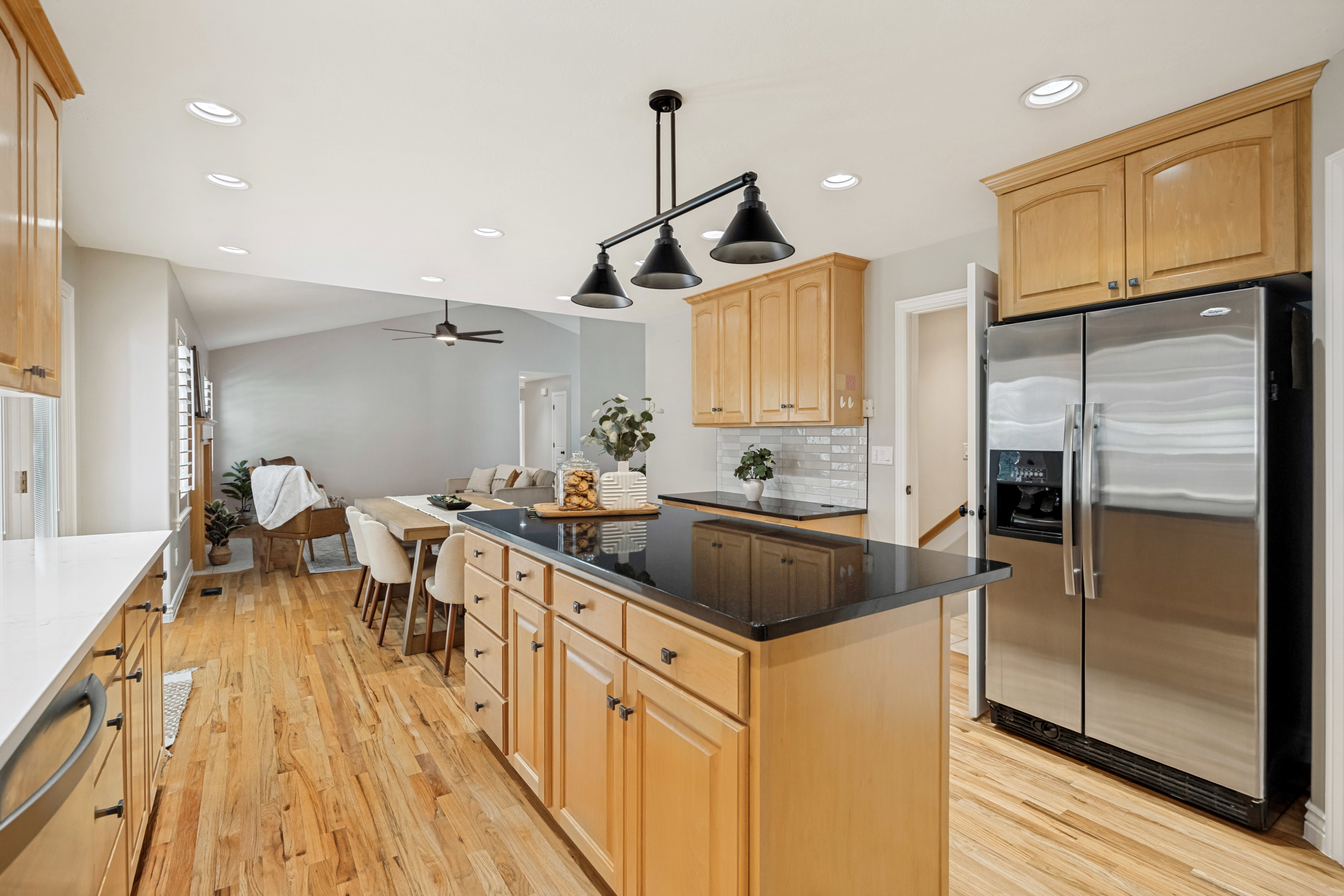 Kitchen view with open concept through dining and living room.