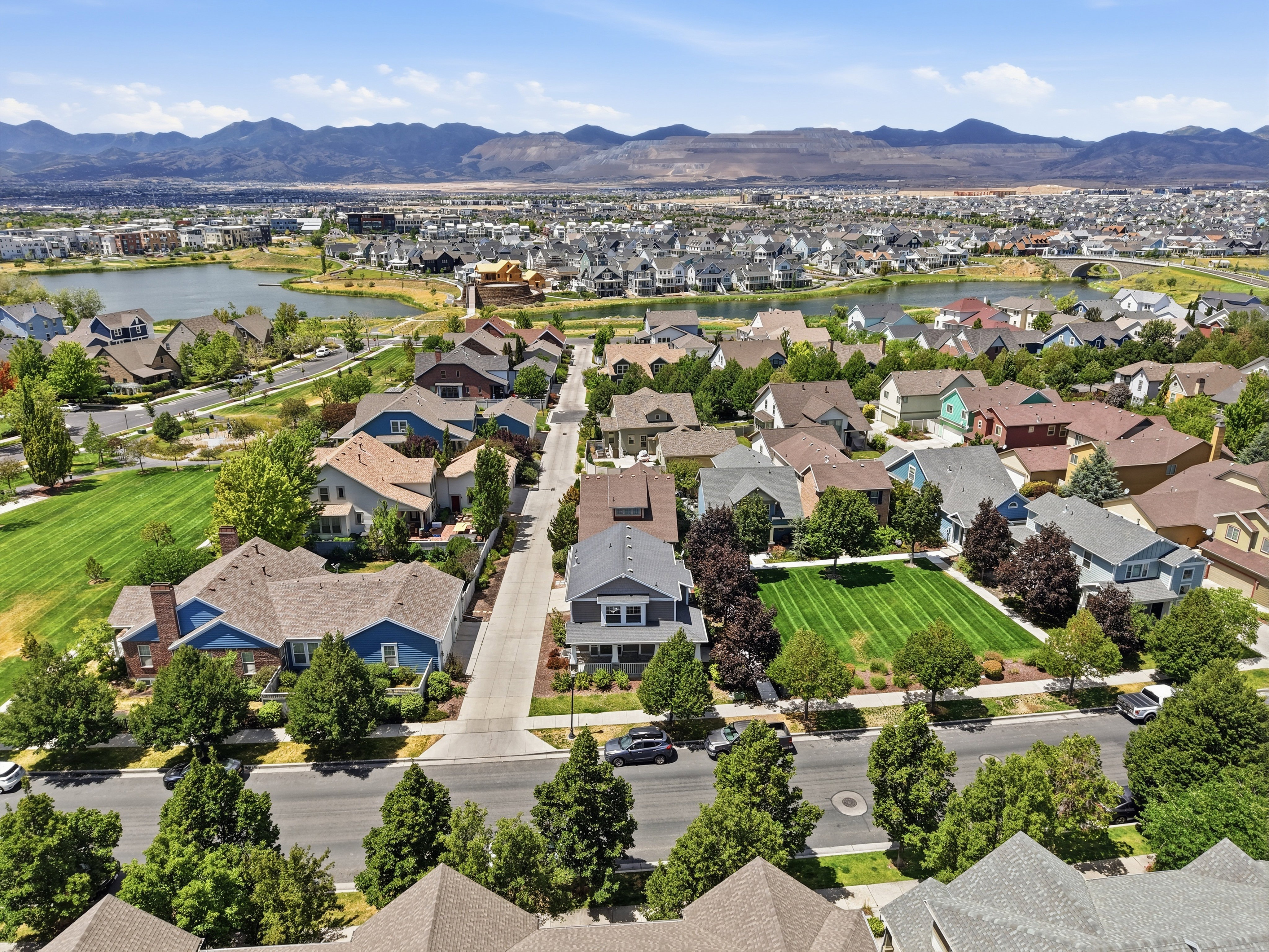Residential neighborhood featuring a variety of single-family homes with diverse architectural styles, tree-lined streets, and manicured lawns