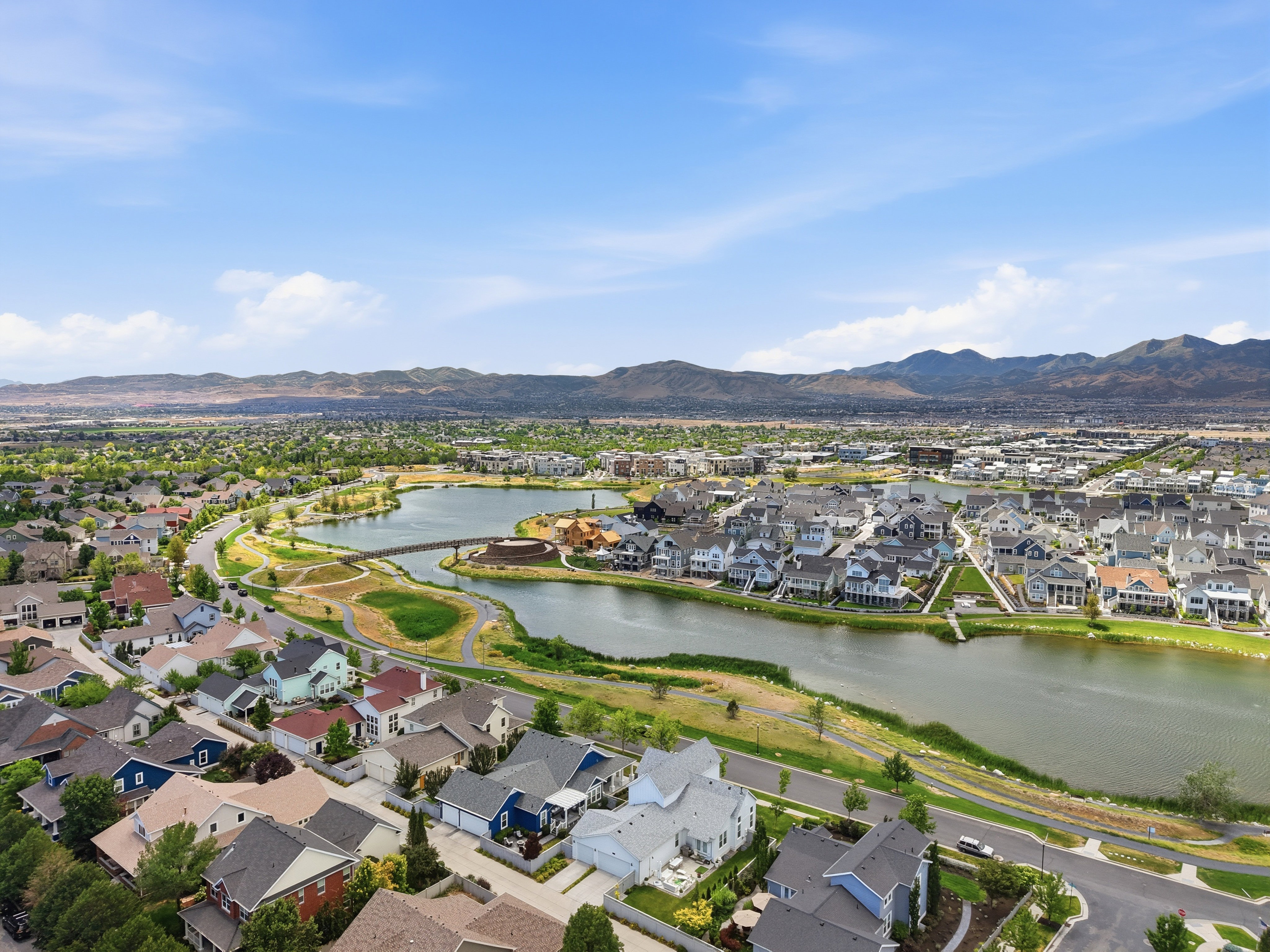 Expansive aerial view showcasing a developed residential area with a prominent body of water