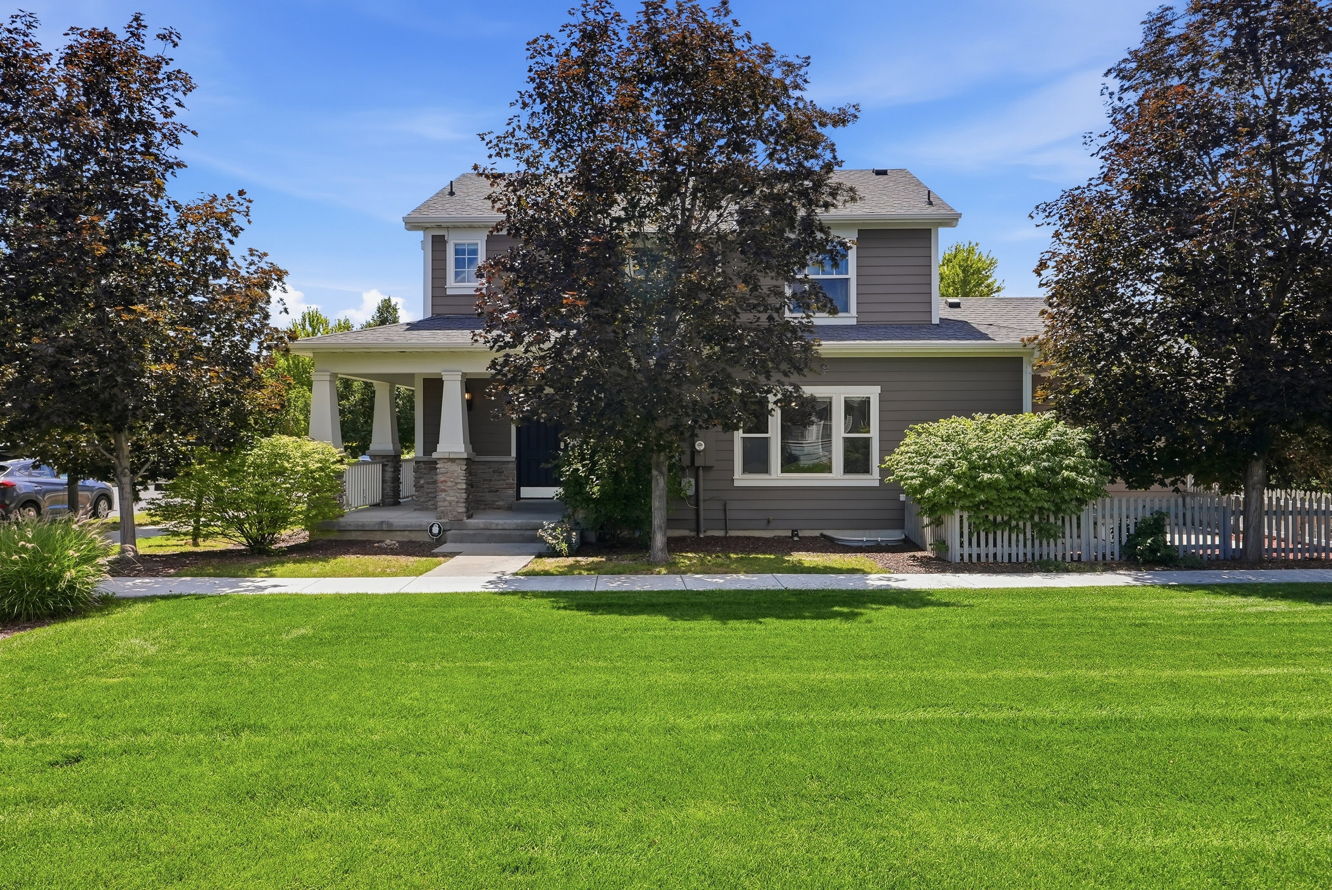 Two-story residence featuring gray siding and white trim