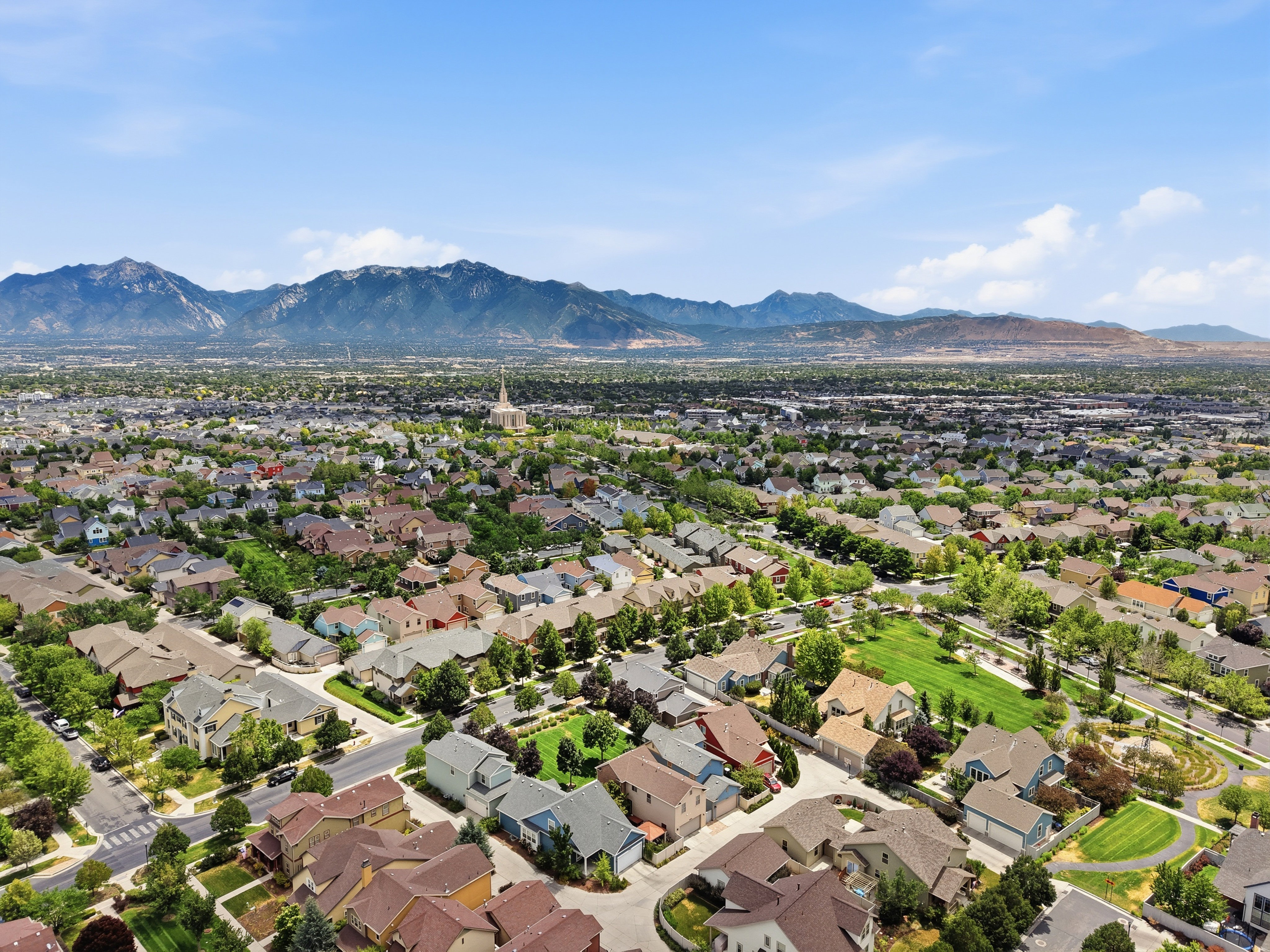 Expansive residential area featuring numerous single-family homes with diverse architectural styles, mature trees, and local streets