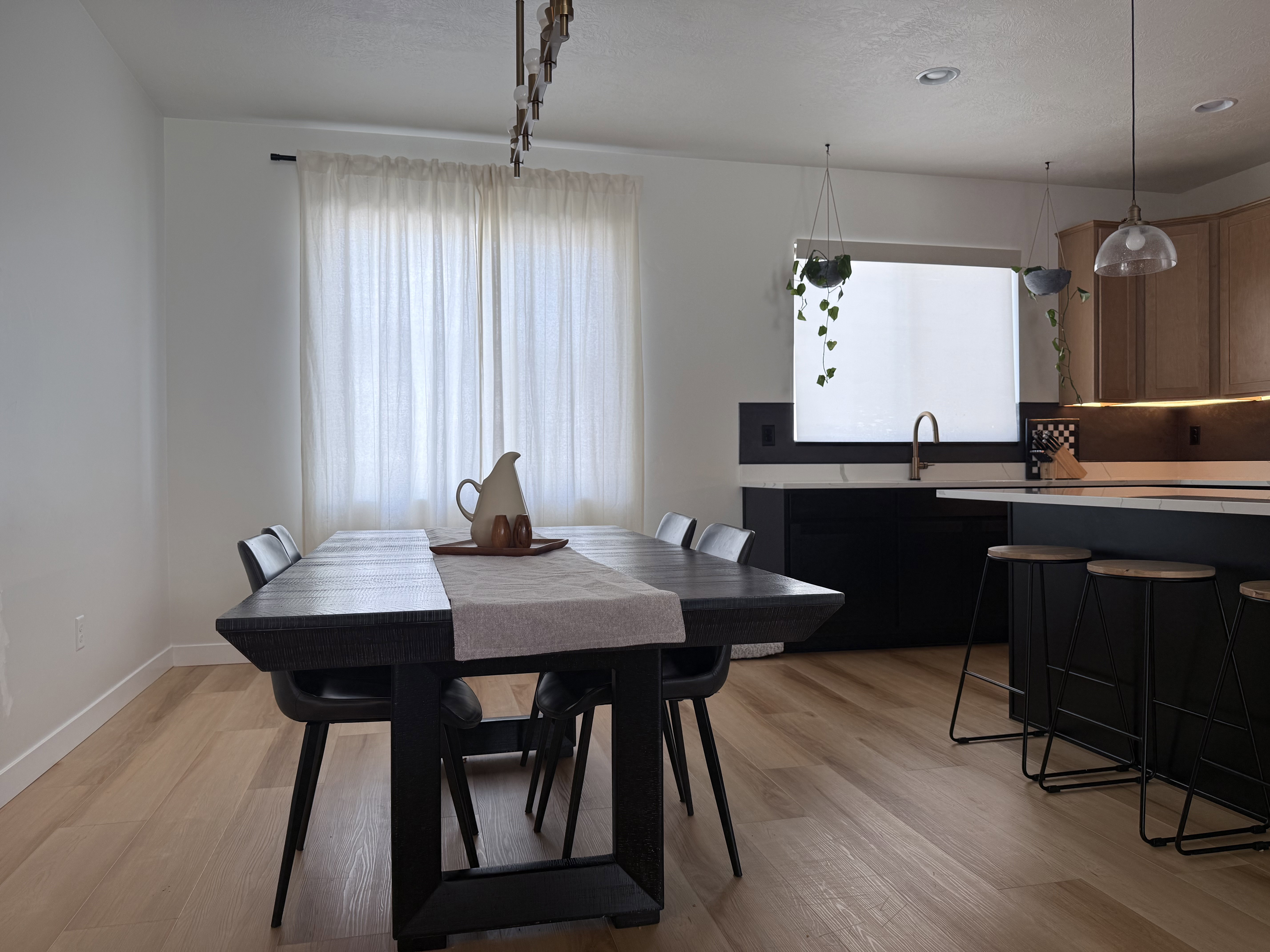 Open-concept living space with light wood-finish flooring