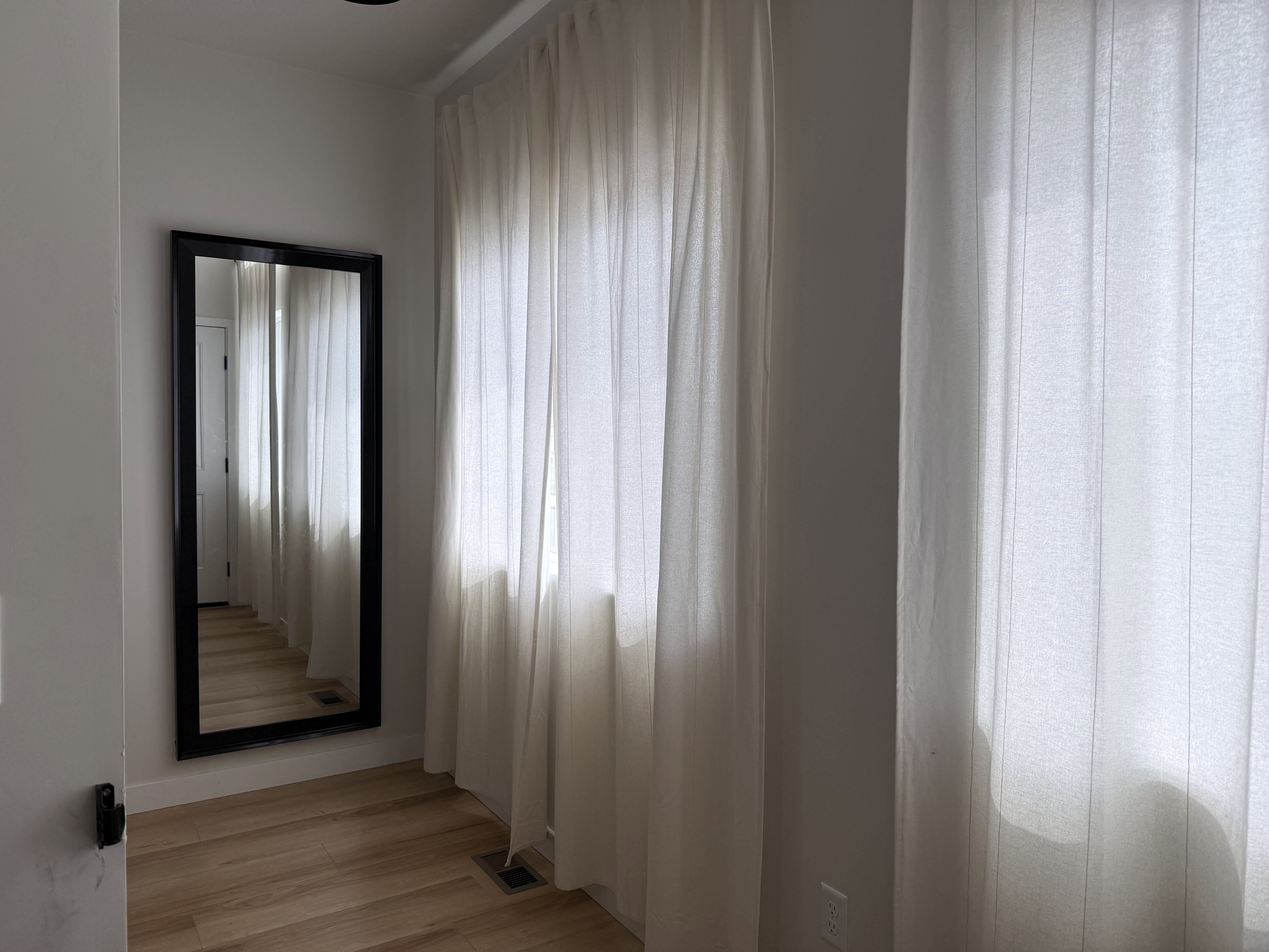 Bright interior space featuring light wood-finish flooring, white walls, and recessed ceiling lighting