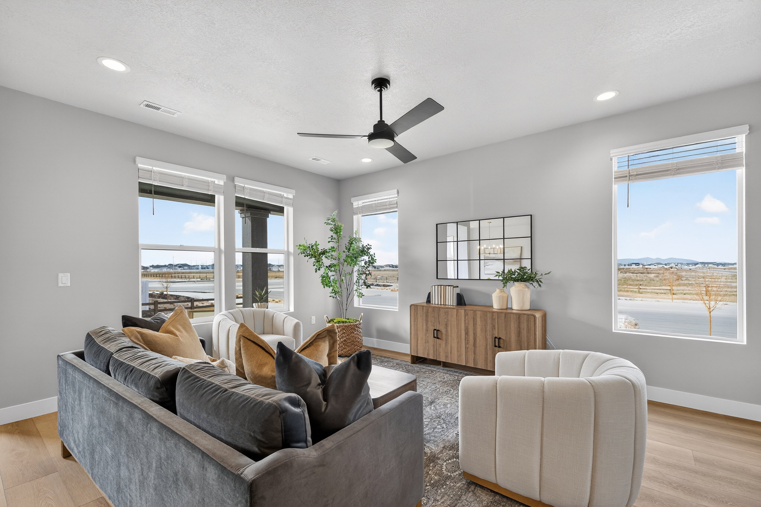 Living area featuring light gray walls, recessed lighting, and wood-finish flooring