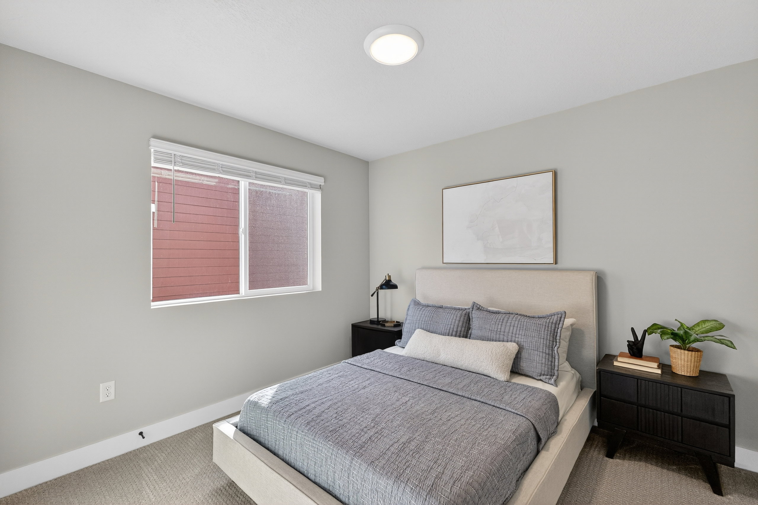 Neutral tone walls with carpeting and white baseboards provide a clean aesthetic