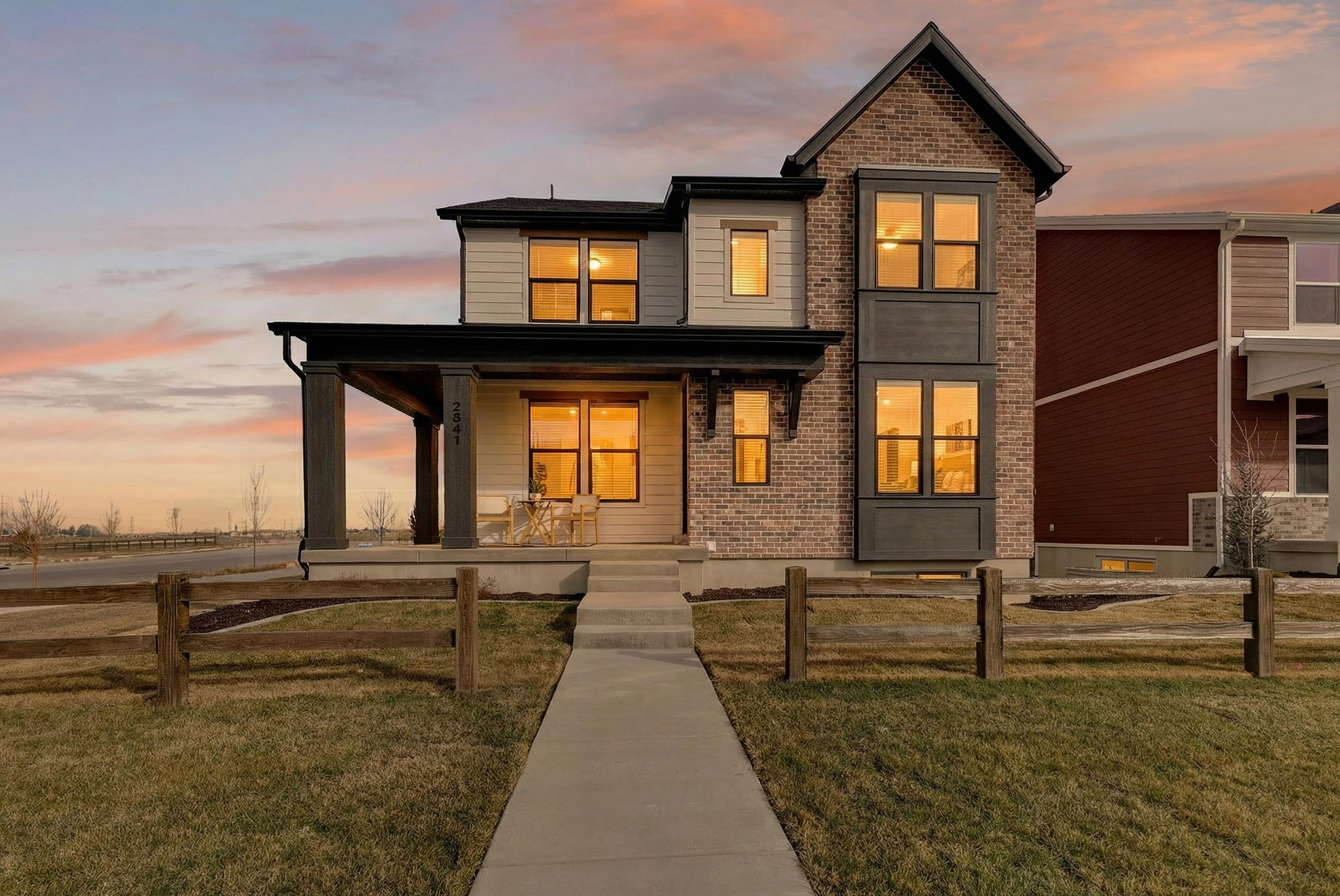 Contemporary residential facade featuring brick and siding accents