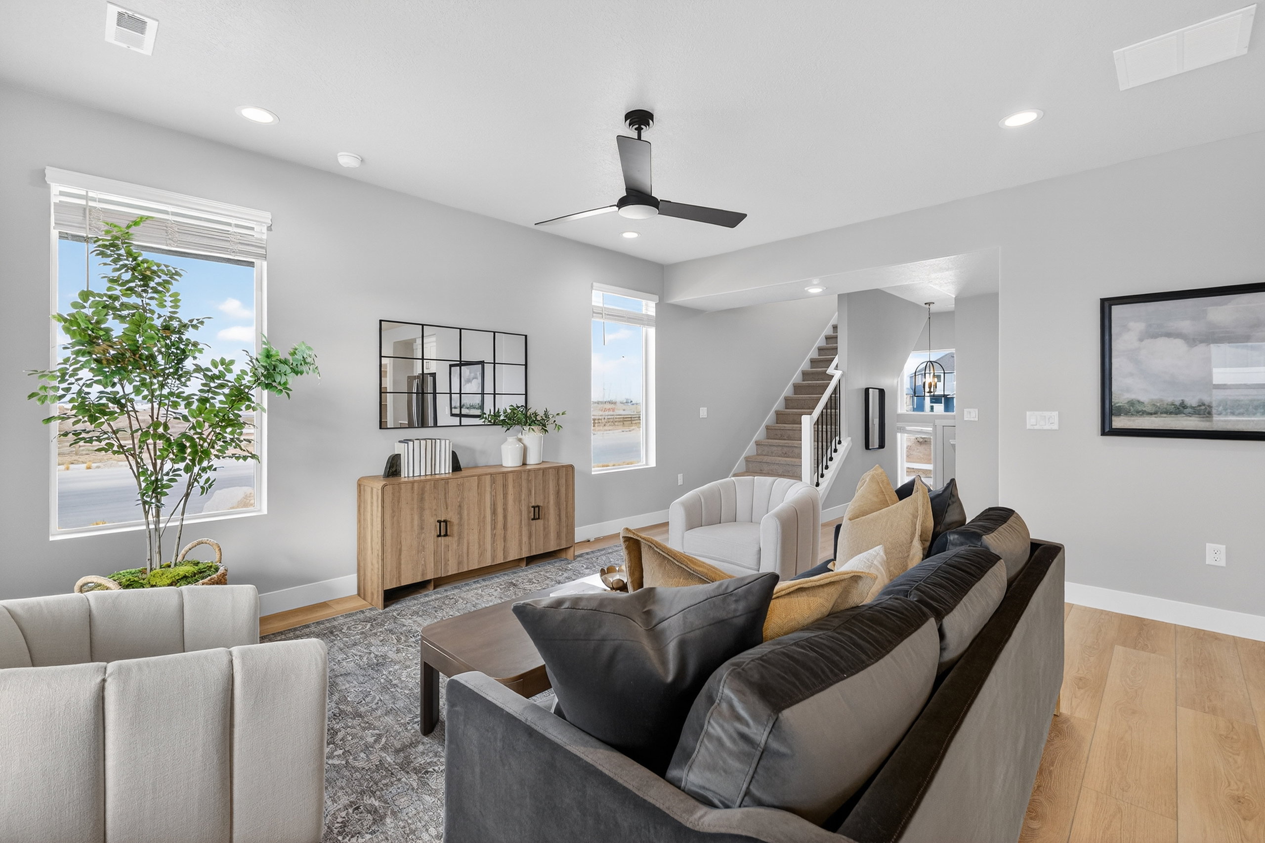 Spacious living area featuring light wood-finish flooring and recessed lighting
