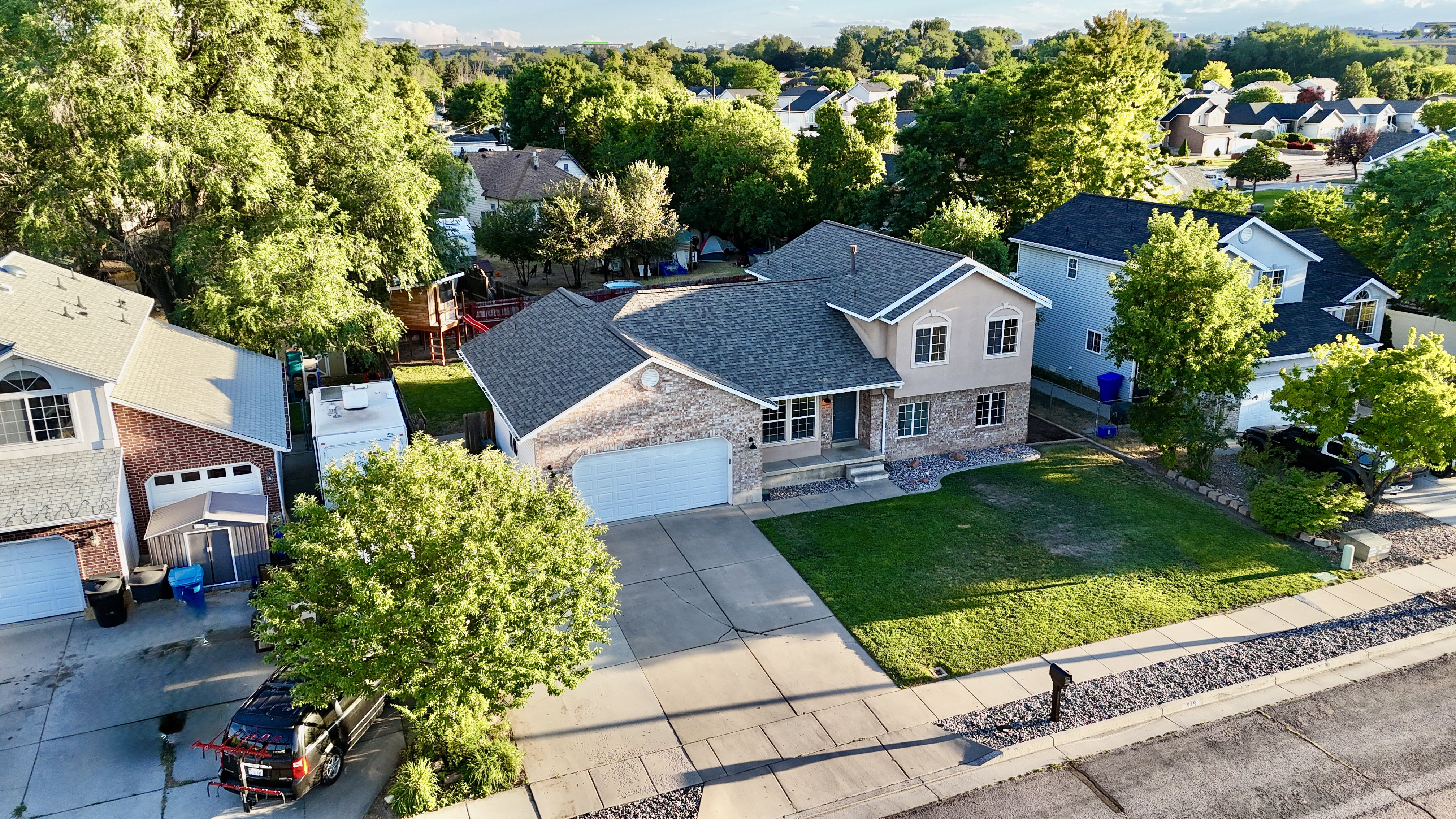 Two-story residence featuring a brick and stucco exterior, an attached two-car garage, and a concrete driveway