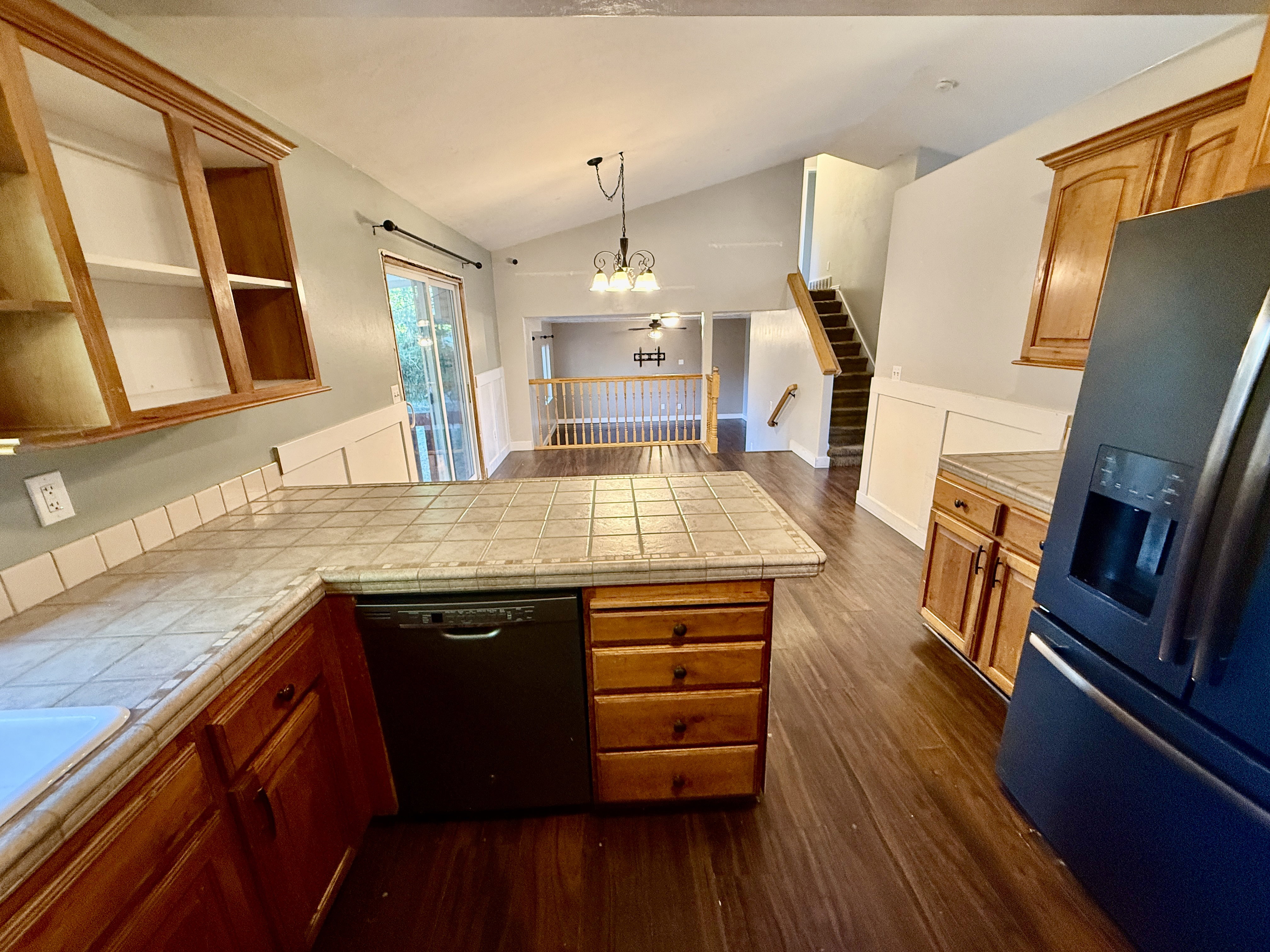 Kitchen featuring tile countertops and wood-finish flooring