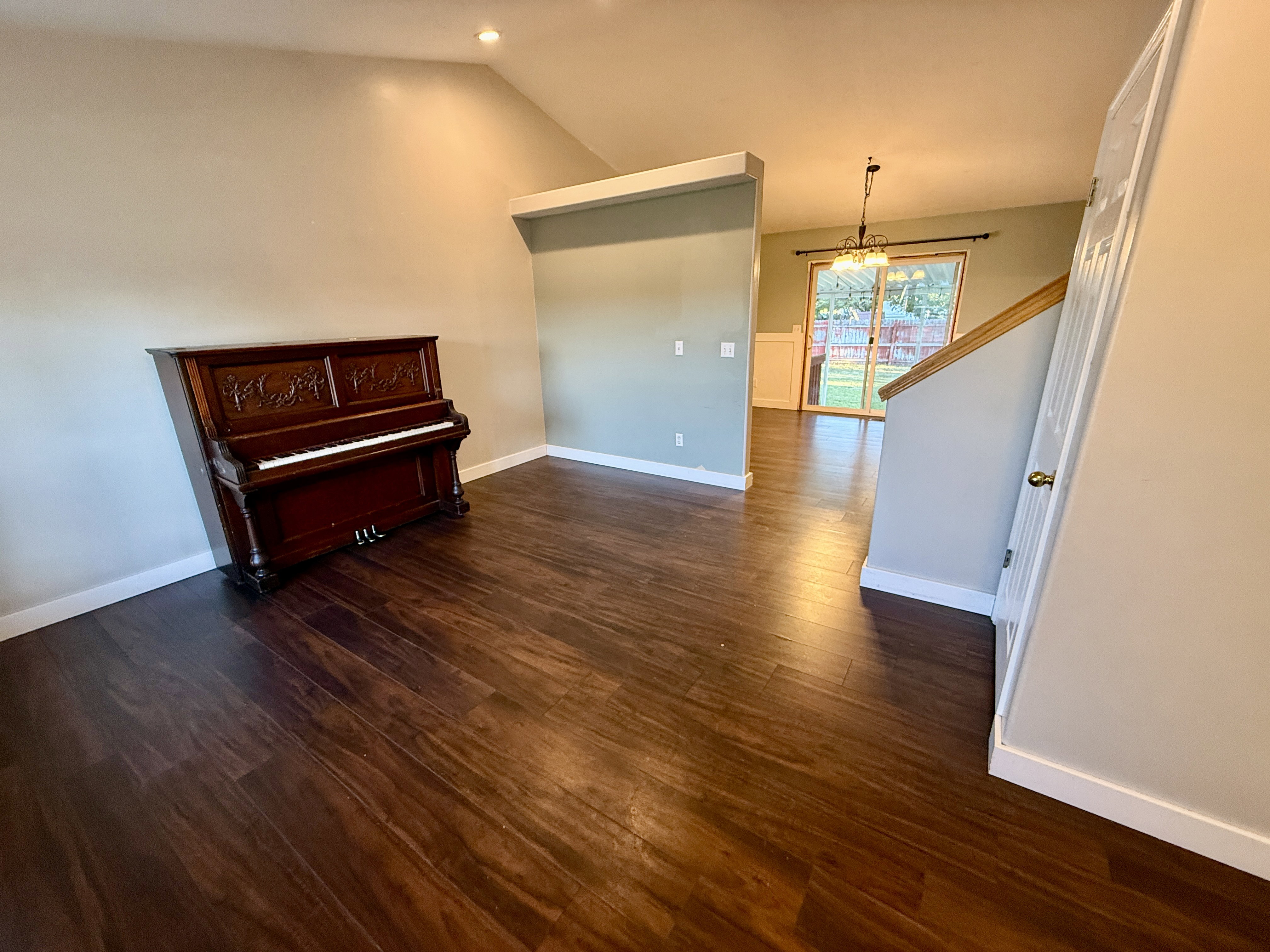 Rich wood-finish flooring throughout, complemented by a vaulted ceiling and recessed lighting