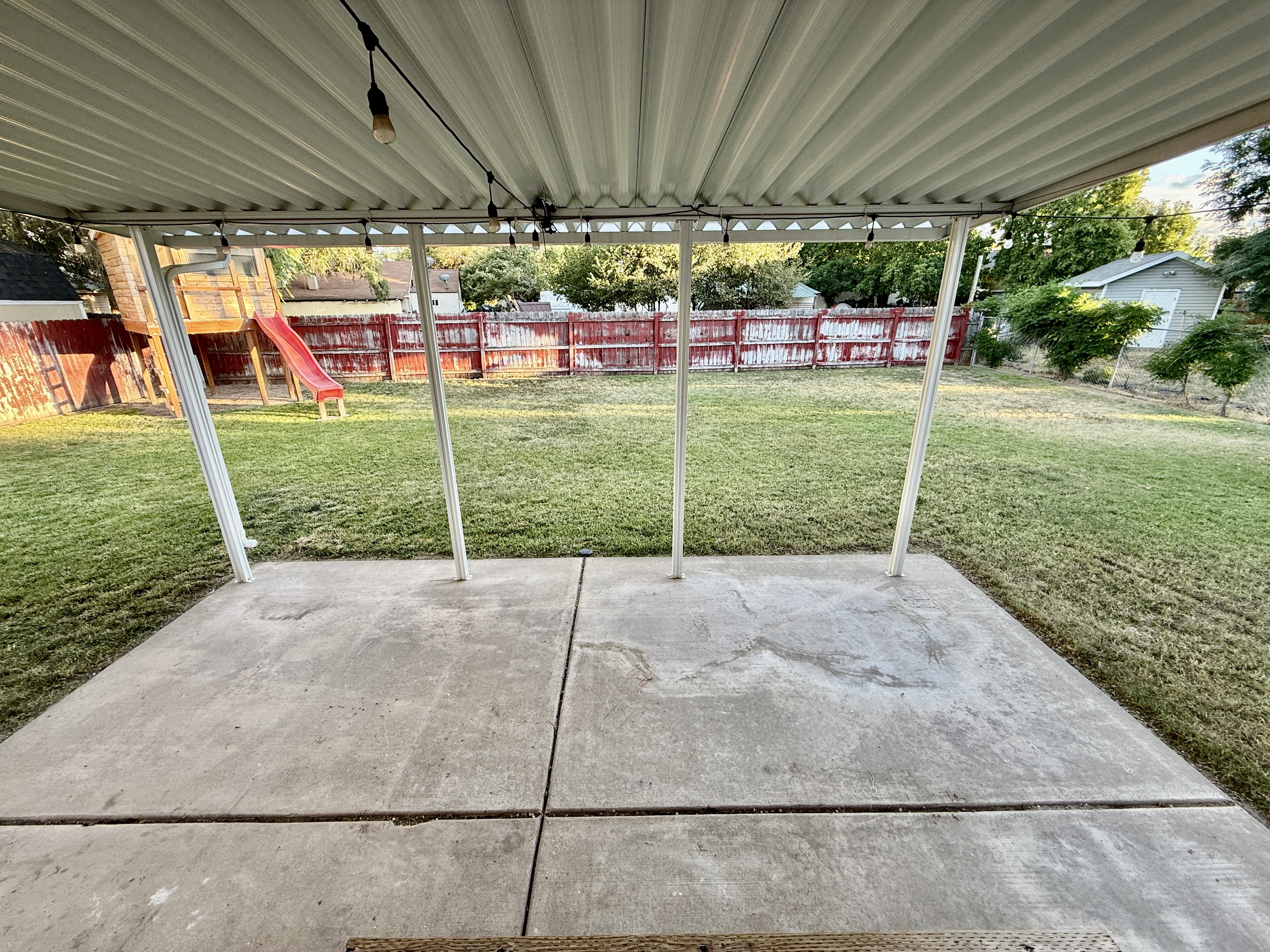 Covered patio featuring a concrete surface and corrugated metal roof