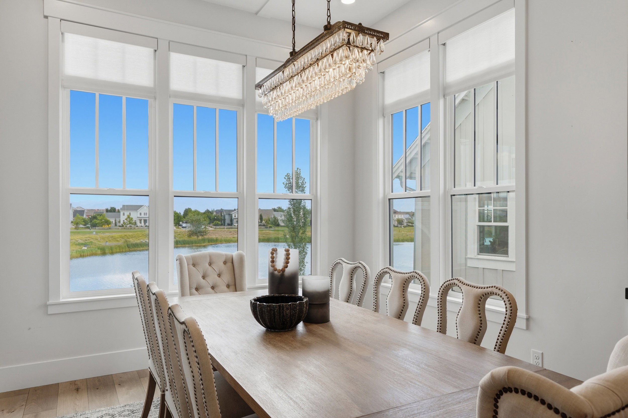 Dining area with extensive fenestration and water scenery
