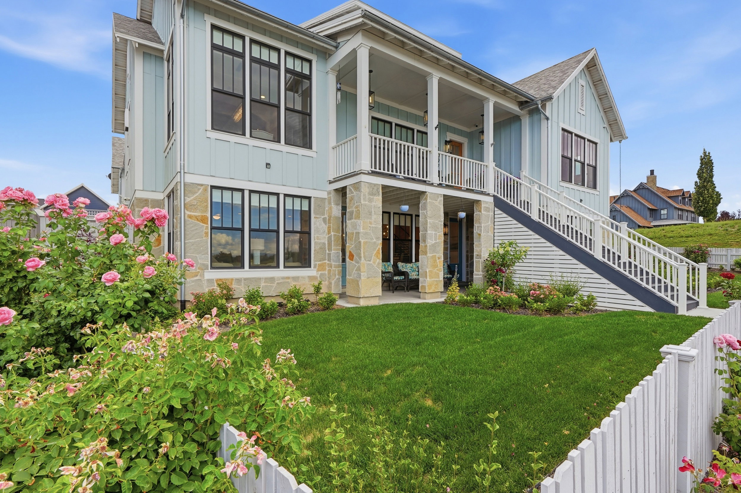Light blue exterior with stone accents and black-framed windows