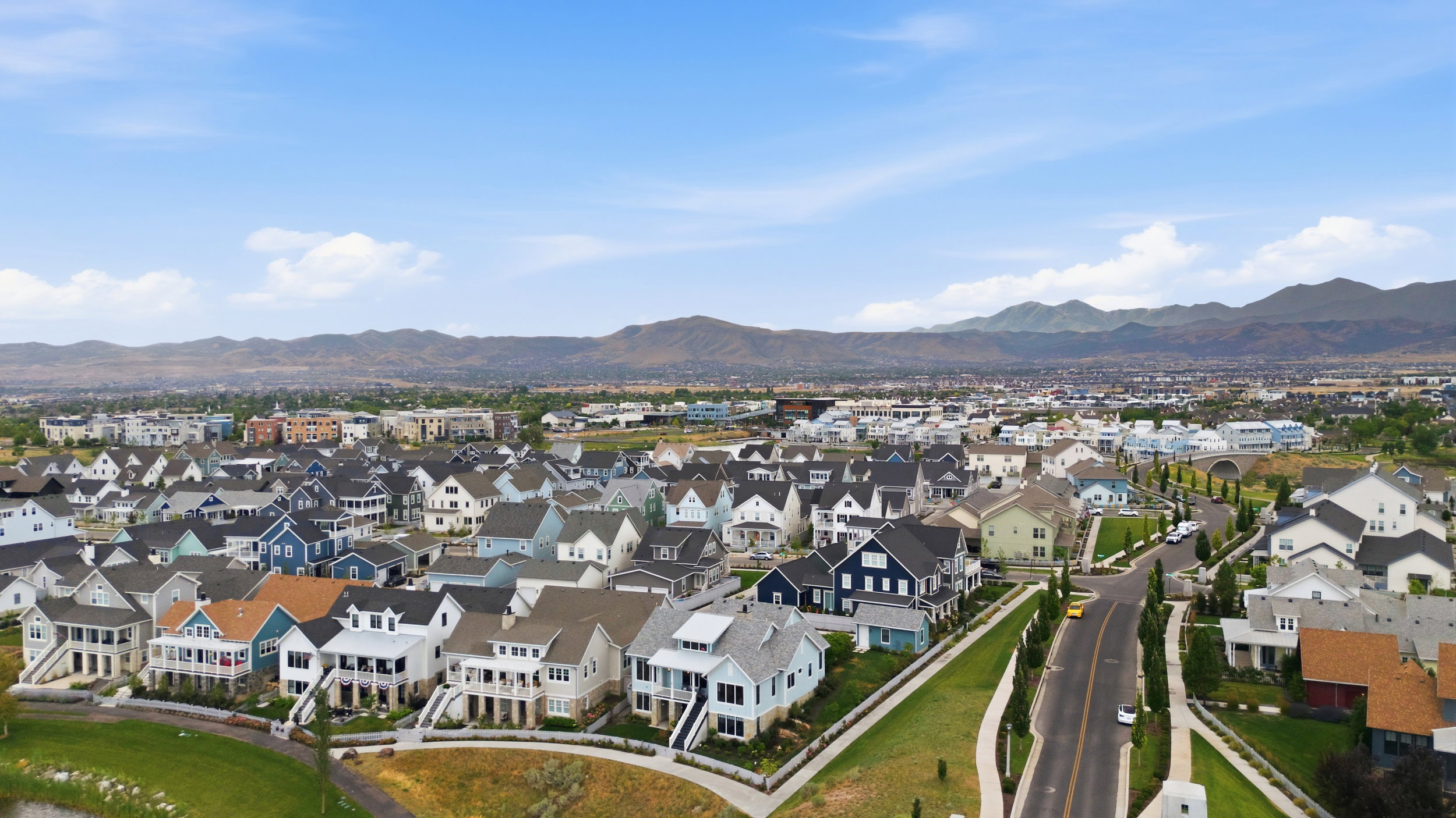 Expansive community featuring diverse home styles, paved streets, and landscaped green spaces