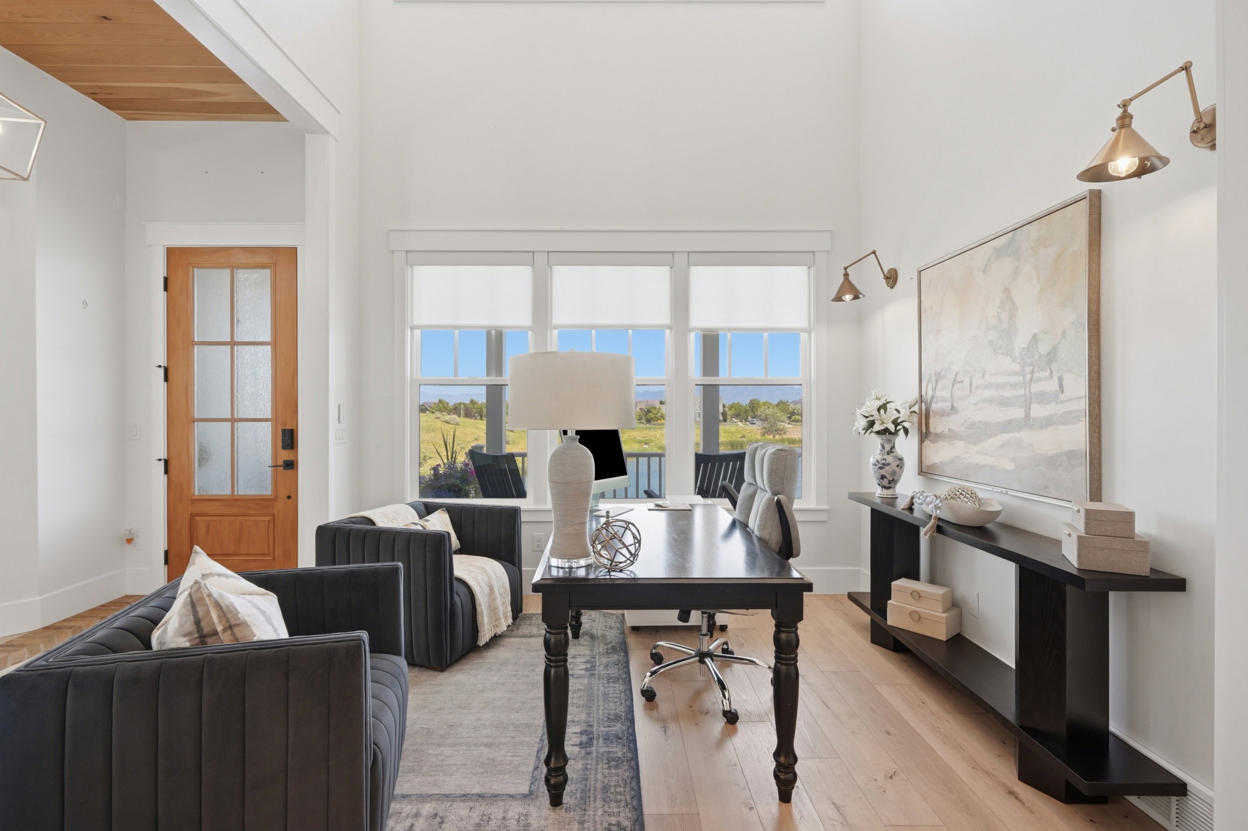 Bright interior space featuring a light wood-finish floor and white walls