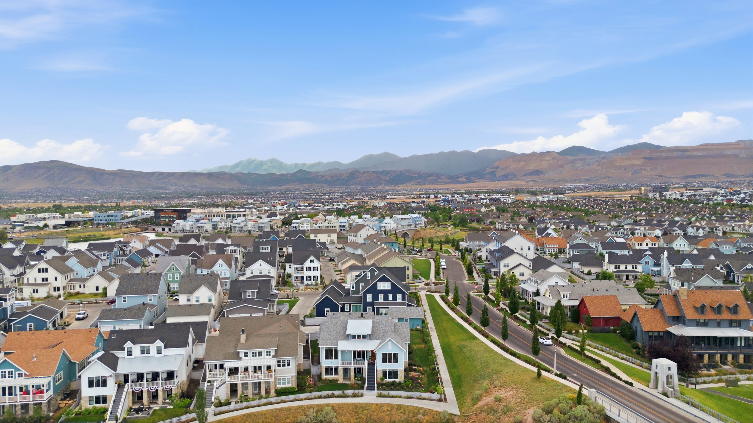 Modern residential development featuring diverse architectural styles, neatly arranged streetscapes, and verdant landscaping