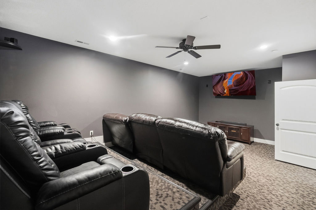 Dedicated media room featuring dark wall paint and patterned carpeting