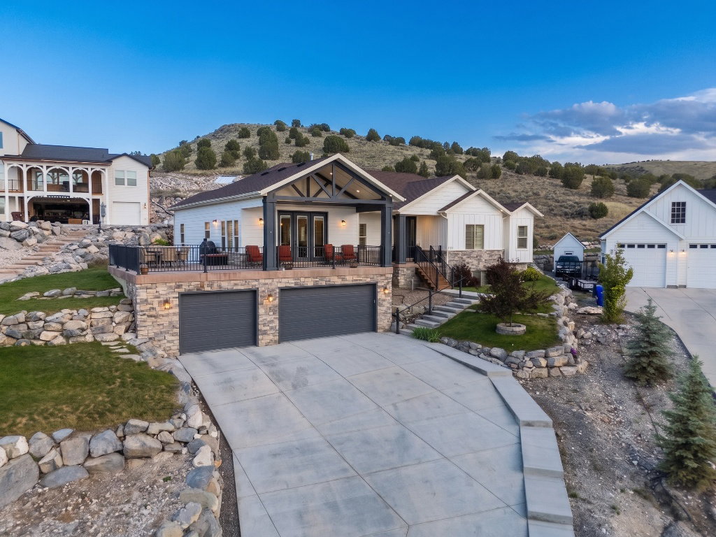 Modern farmhouse-style home with white siding and stone accents