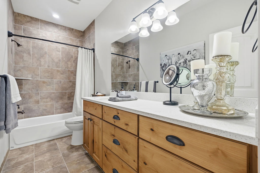 Bathroom featuring a wood-finish vanity with a light-toned countertop