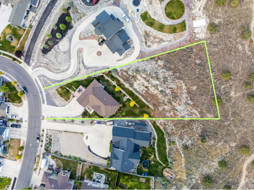 Aerial view showcasing a substantial undeveloped lot