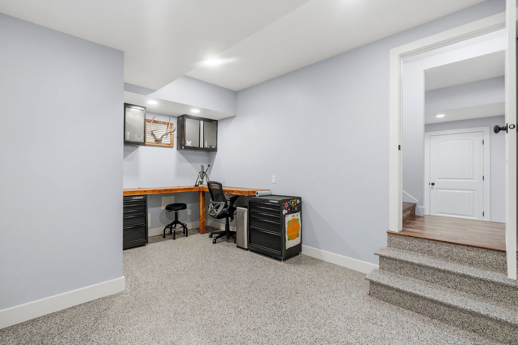 Finished lower level with carpeted flooring, light grey painted walls, and recessed lighting