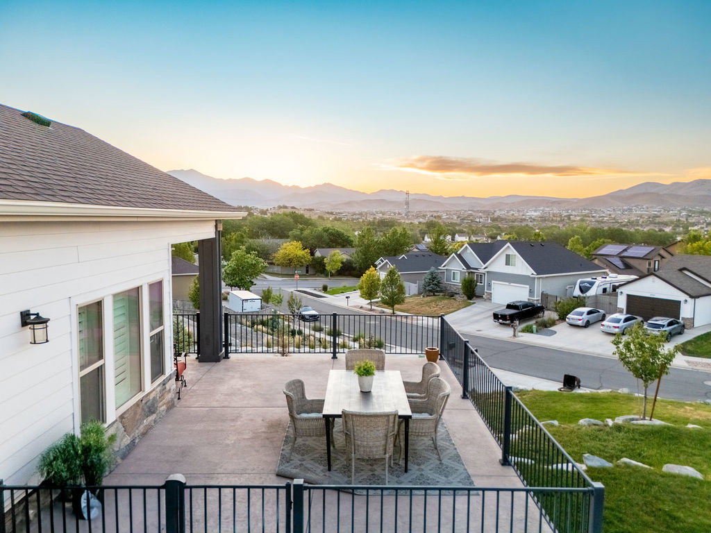 Expansive concrete patio featuring a metal railing system