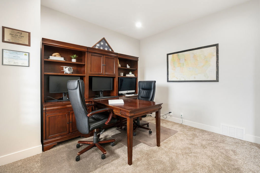 Built-in wood-finish cabinetry and shelving unit with integrated desk space