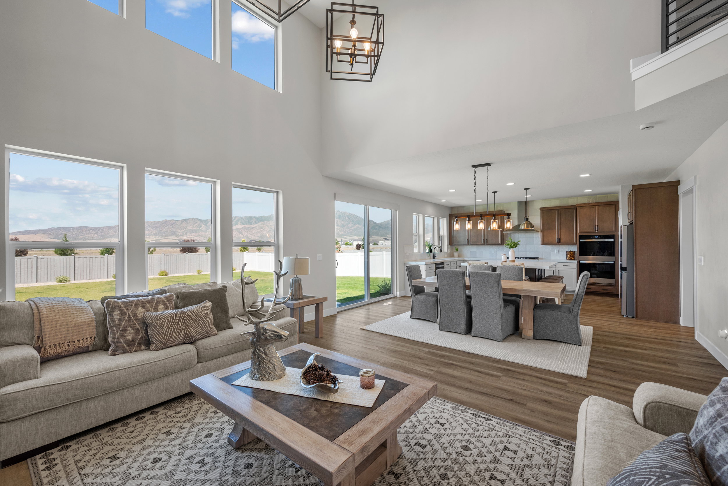Open-concept living space featuring high ceilings and large windows