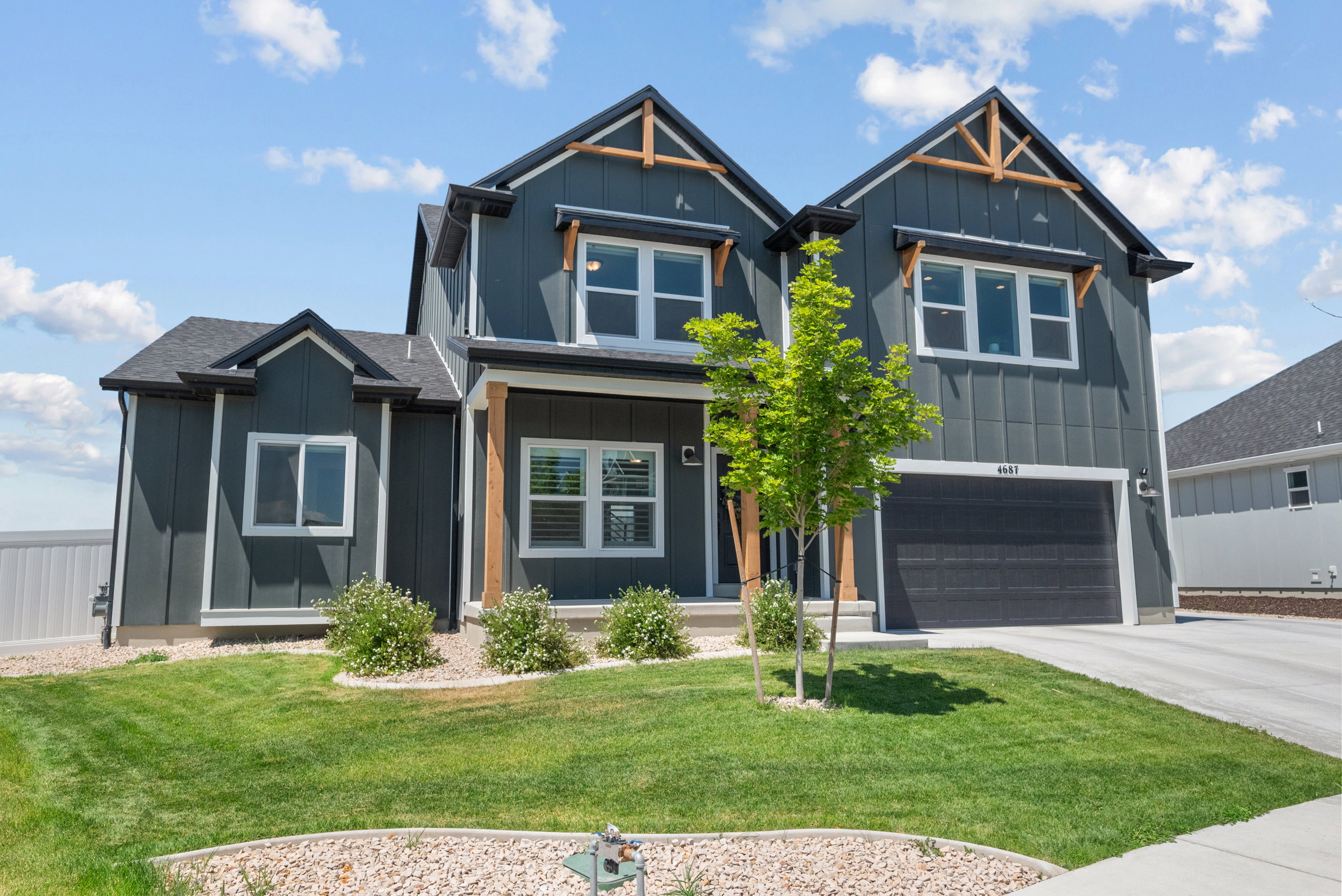 Contemporary exterior featuring dark gray vertical siding with white trim accents