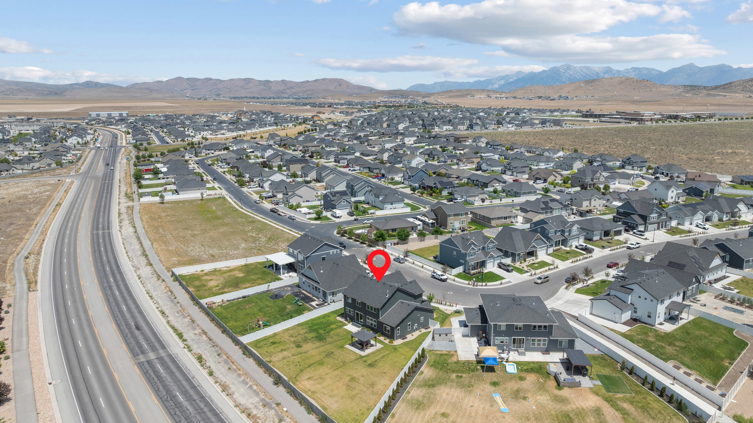 Aerial perspective showcasing a residential community with distant mountain ranges
