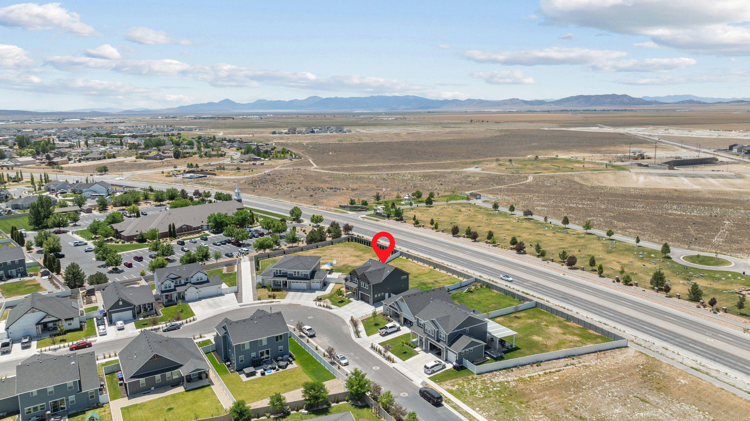 Aerial overview of a residential neighborhood with distant mountains